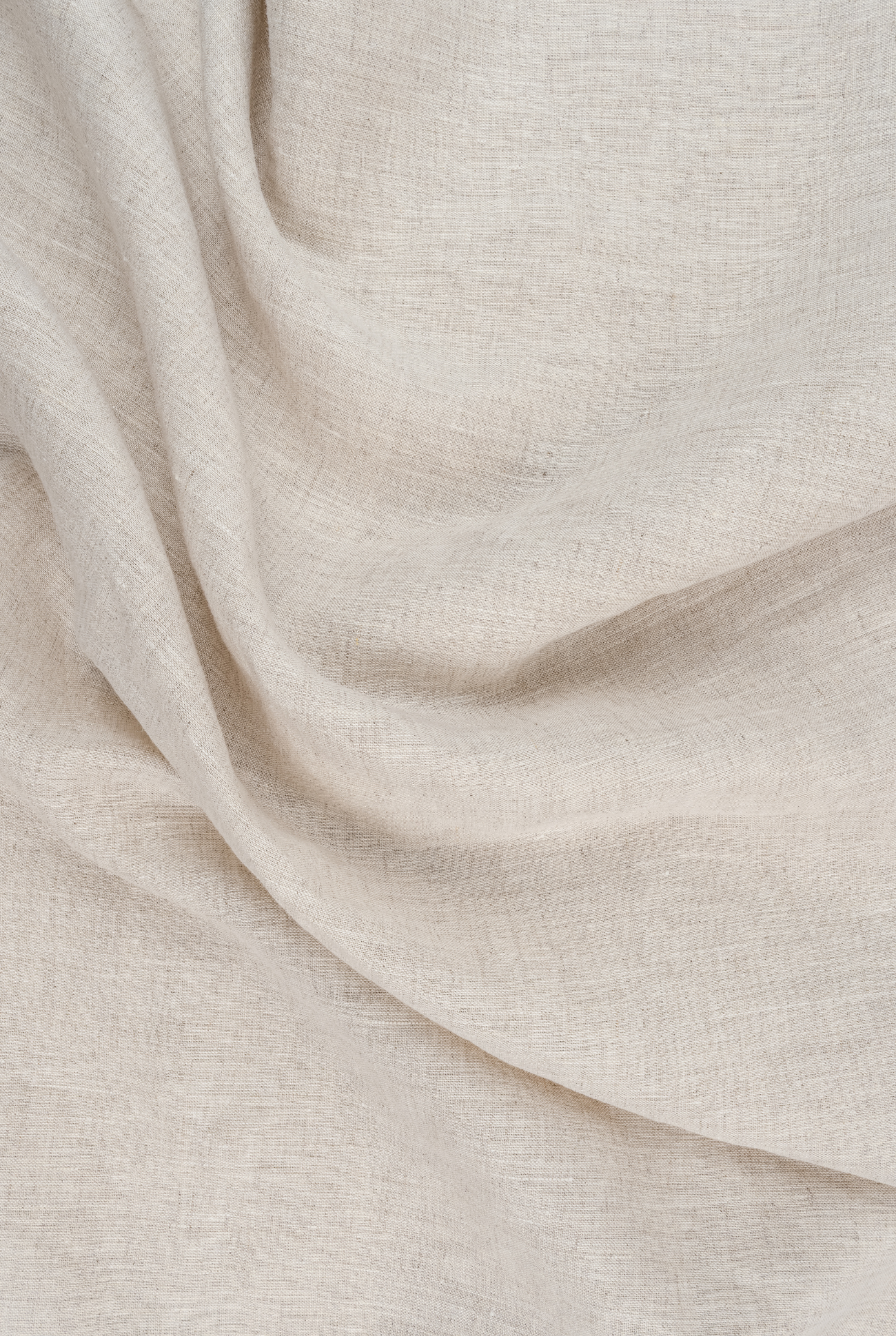 Close-up view of beige fabric with visible weave and soft folds.