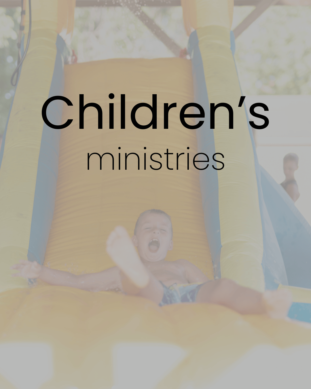 Child sliding down slide at VBS at FBCE