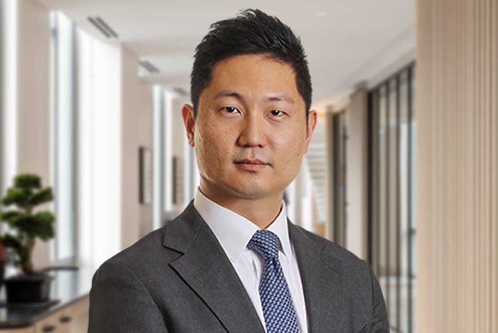 Professional man in a suit standing in a modern office building.