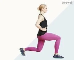 A woman in a black tank top and pink leggings doing lunges with hands on hips against a light background.