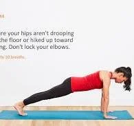 Woman performing a plank exercise on a blue yoga mat.