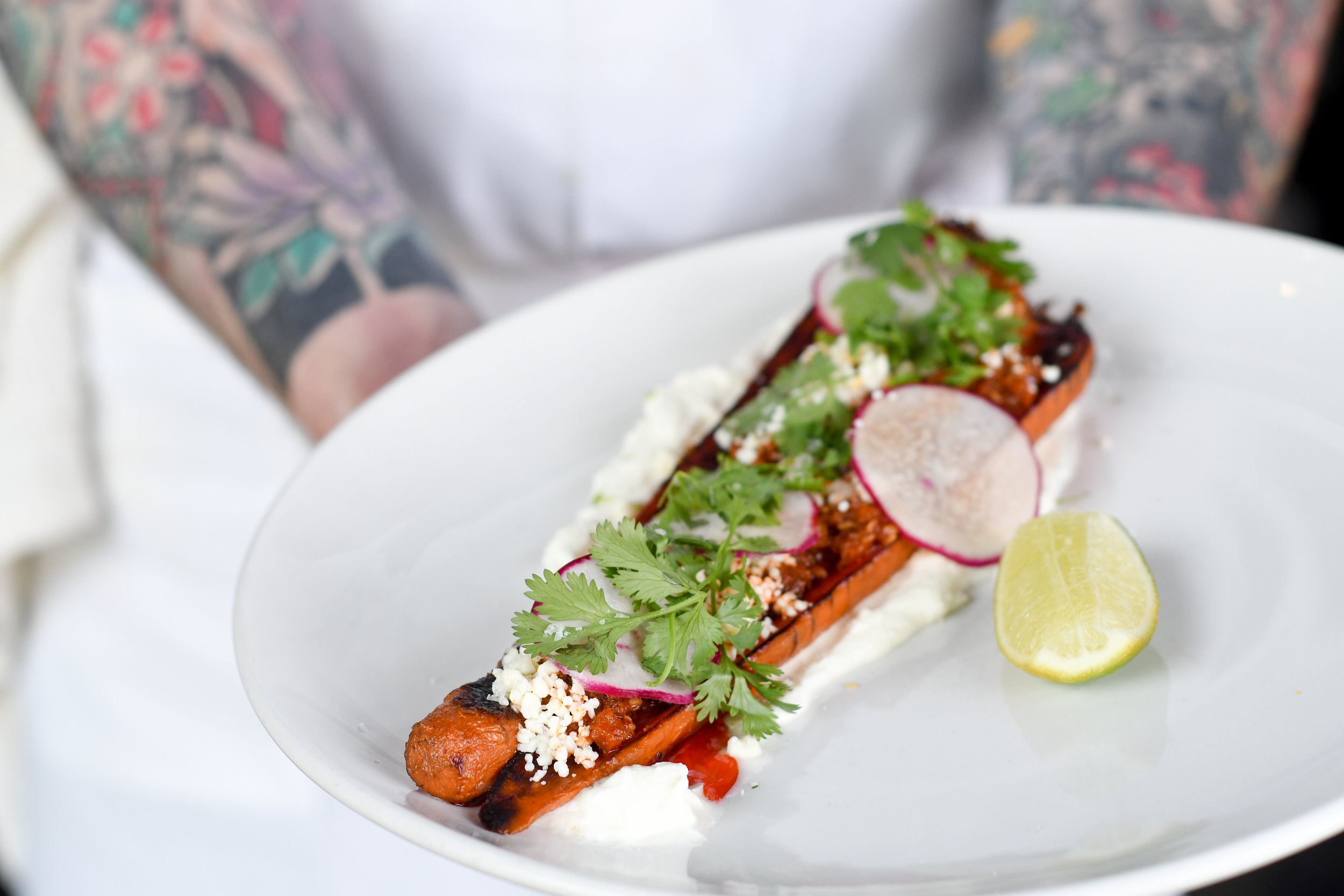 Spring:  Carrots confit in smoked beef fat, salted yogurt, carrot and hazelnut salsa macha, cotija, herbs, lime 