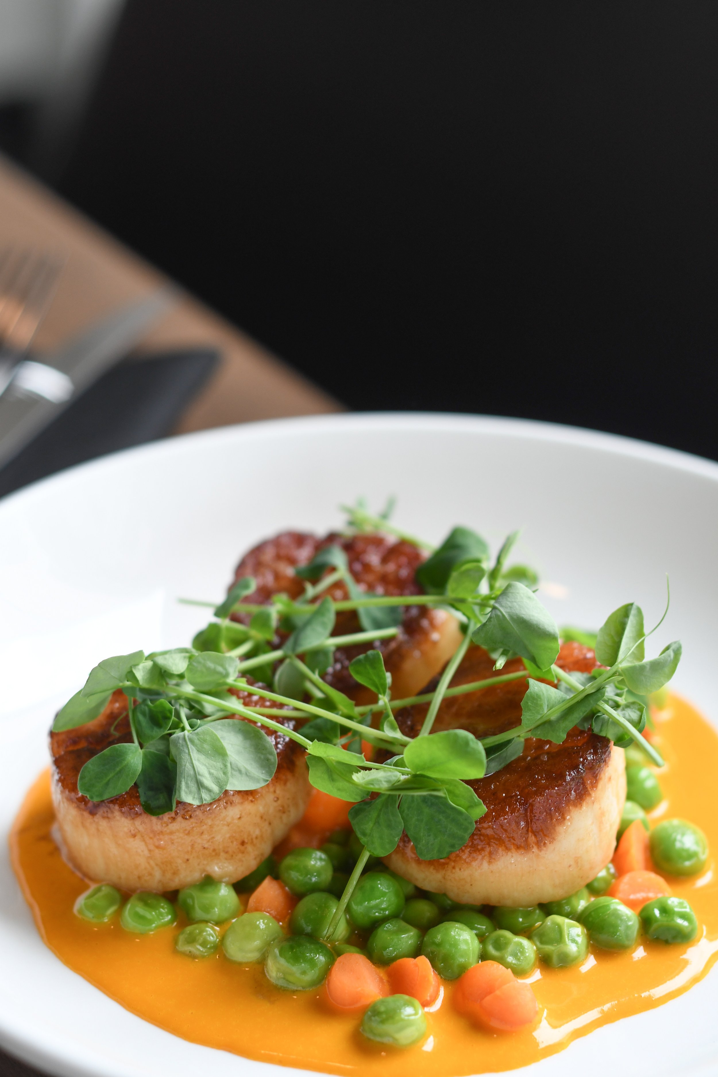 Spring:  Seared scallops, peas and pickled carrots, reduced carrot sauce, pea shoots 