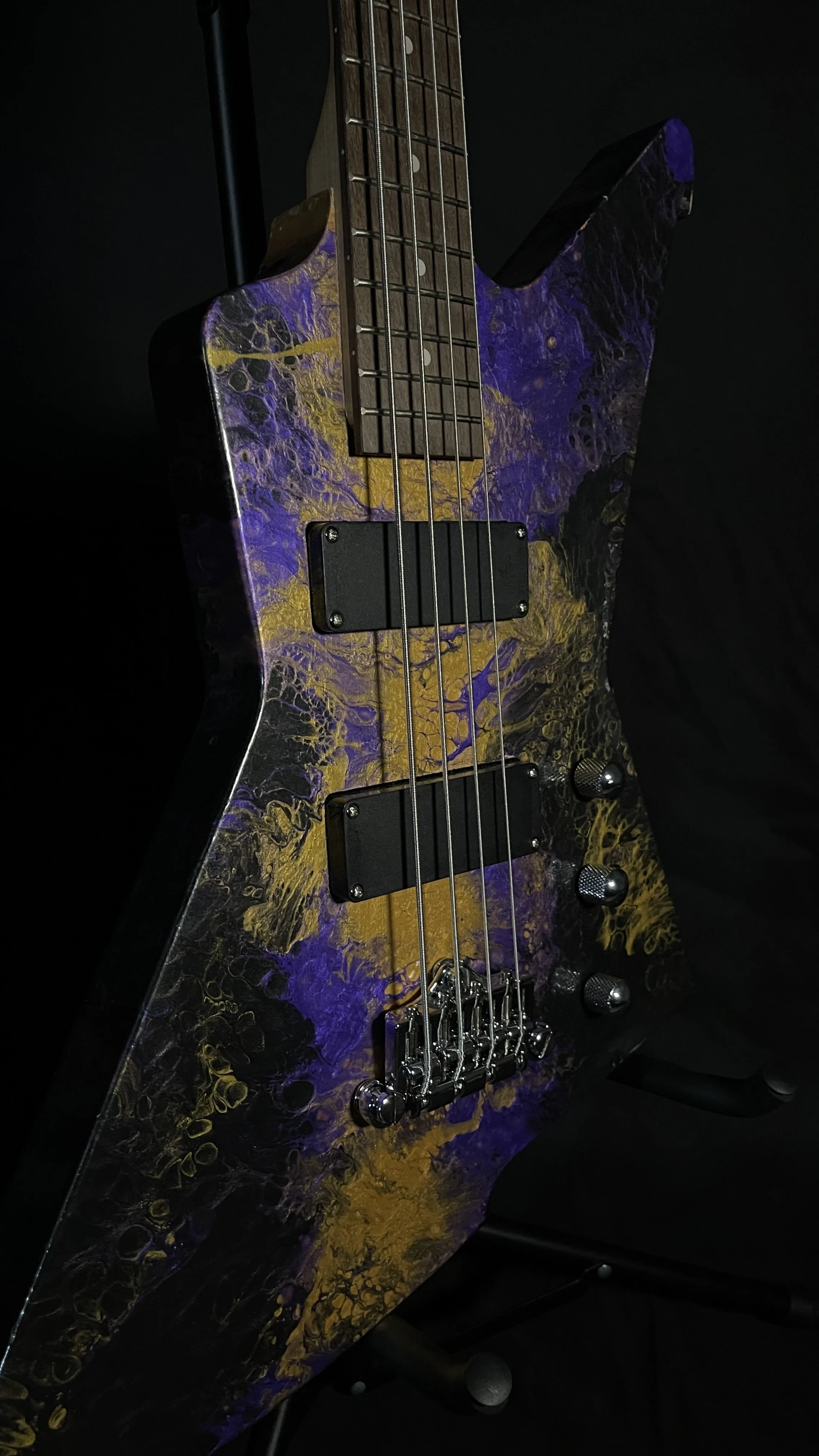 Purple, gold and black acrylic poured electric bass named Delphi from Grainrot Guitars.