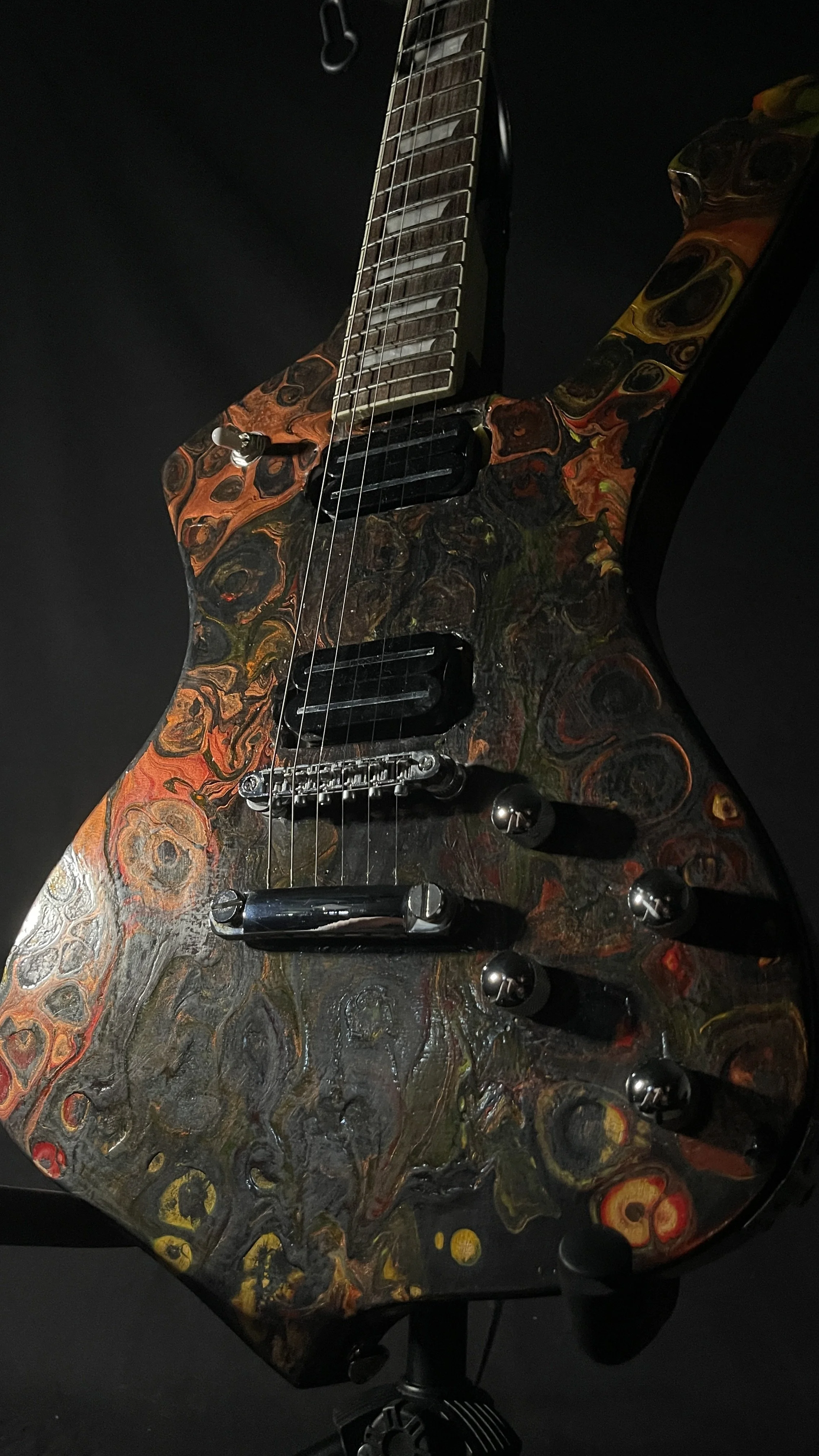 A black, red, orange and yellow electric guitar name Hephaestus by Grainrot Guitars