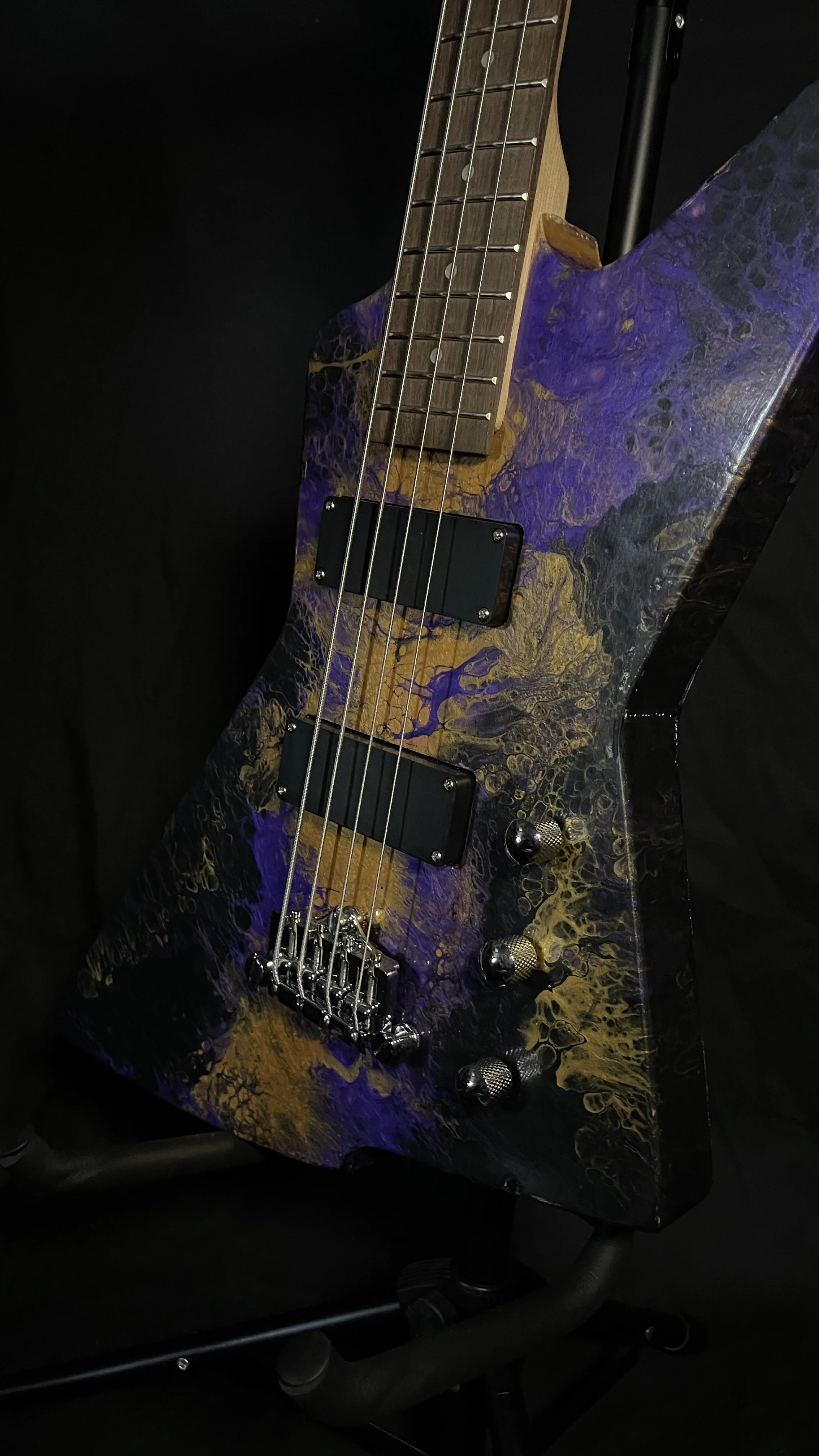 Purple, gold and black acrylic poured electric bass named Delphi from Grainrot Guitars.