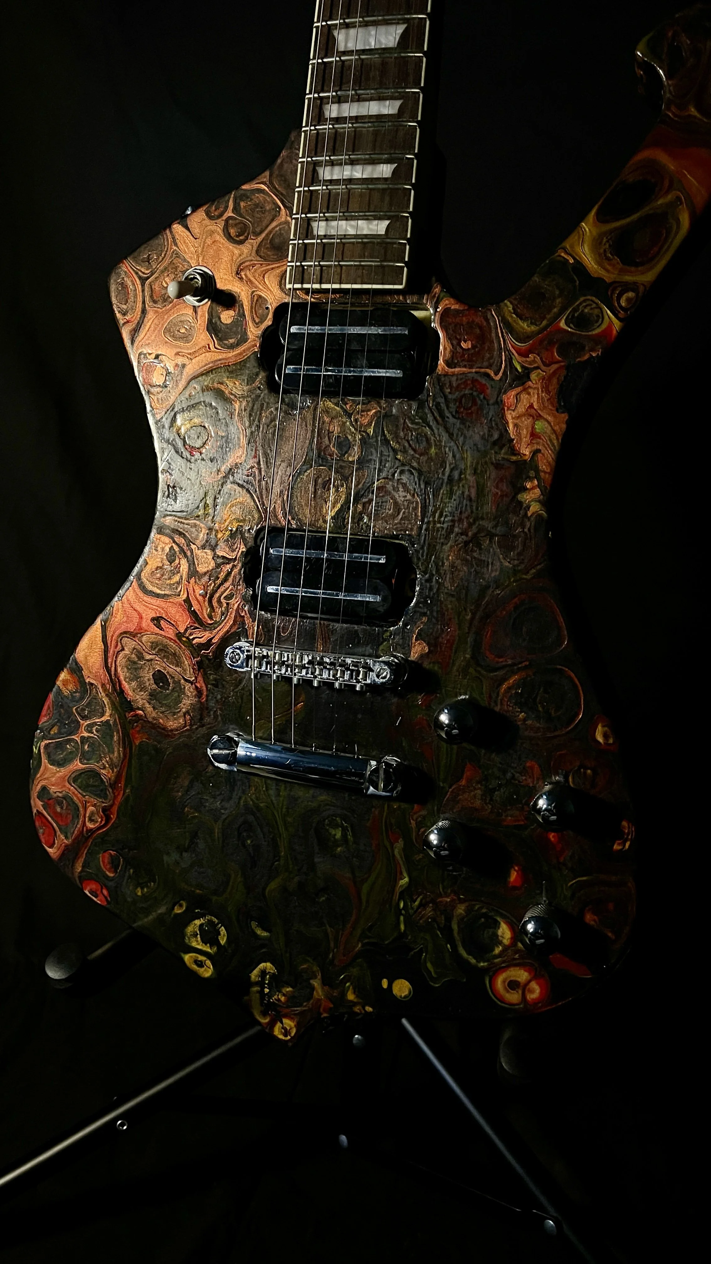 A black, red, orange and yellow electric guitar name Hephaestus by Grainrot Guitars