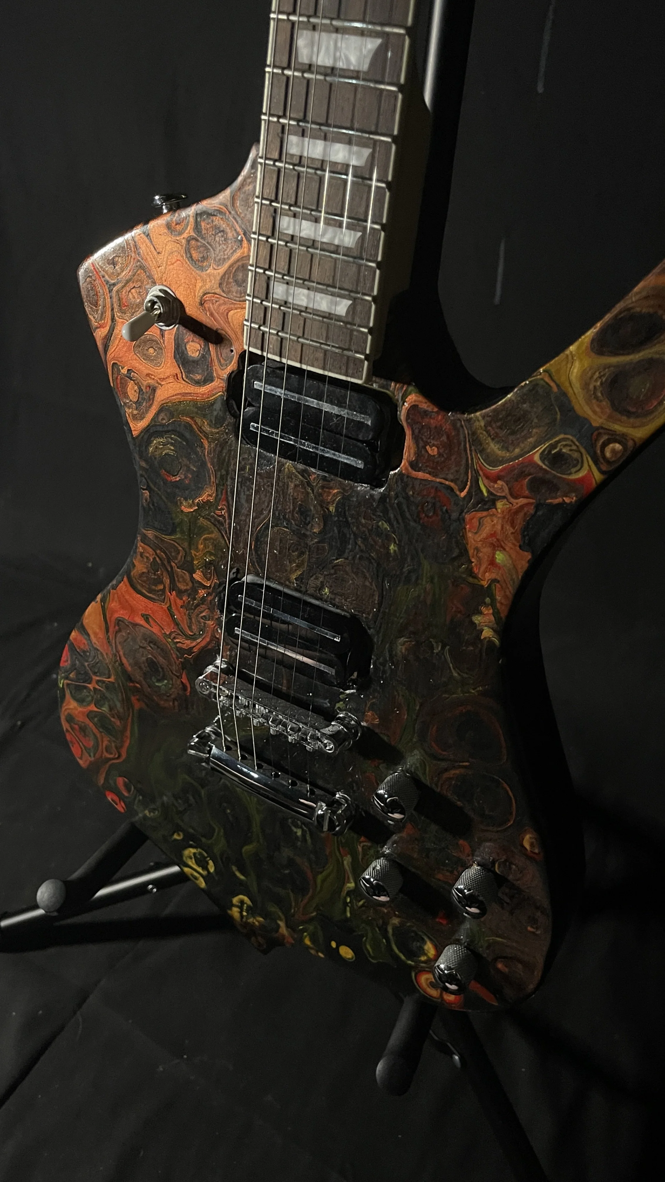 A black, red, orange and yellow electric guitar name Hephaestus by Grainrot Guitars