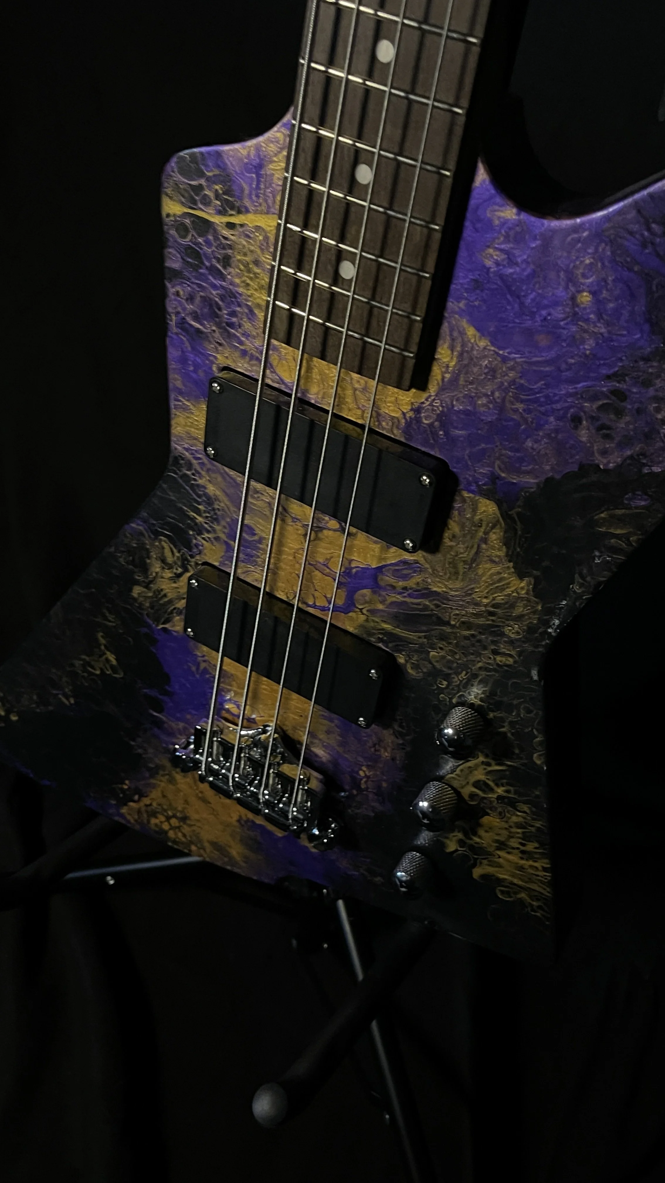 Purple, gold and black acrylic poured electric bass named Delphi from Grainrot Guitars.