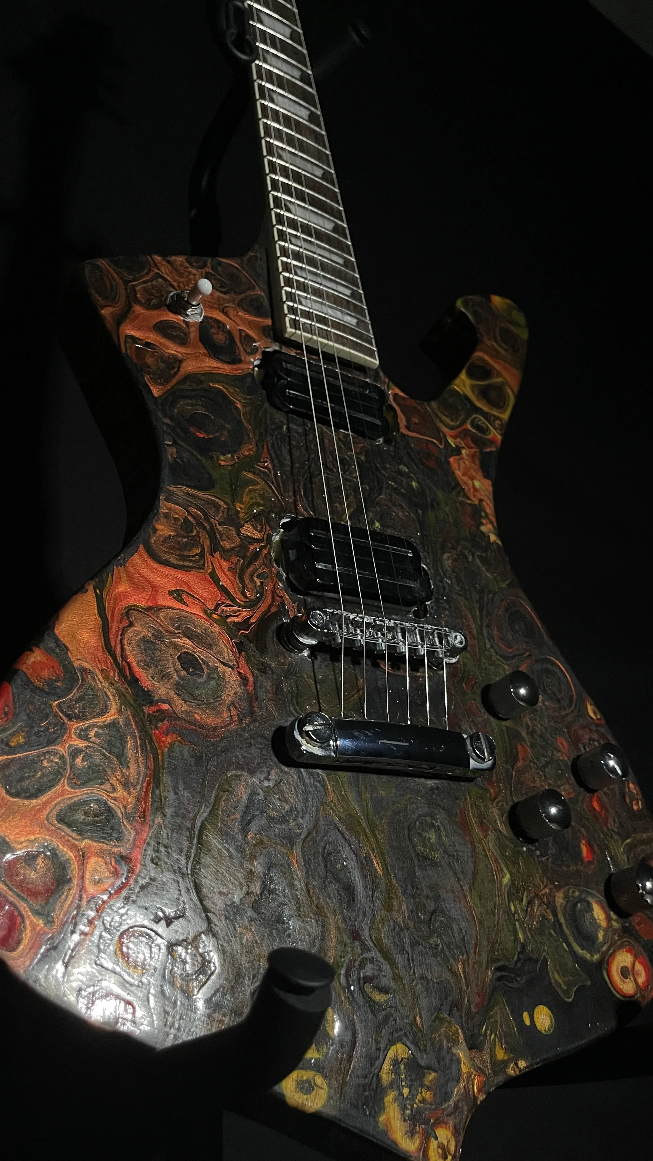 A black, red, orange and yellow electric guitar name Hephaestus by Grainrot Guitars