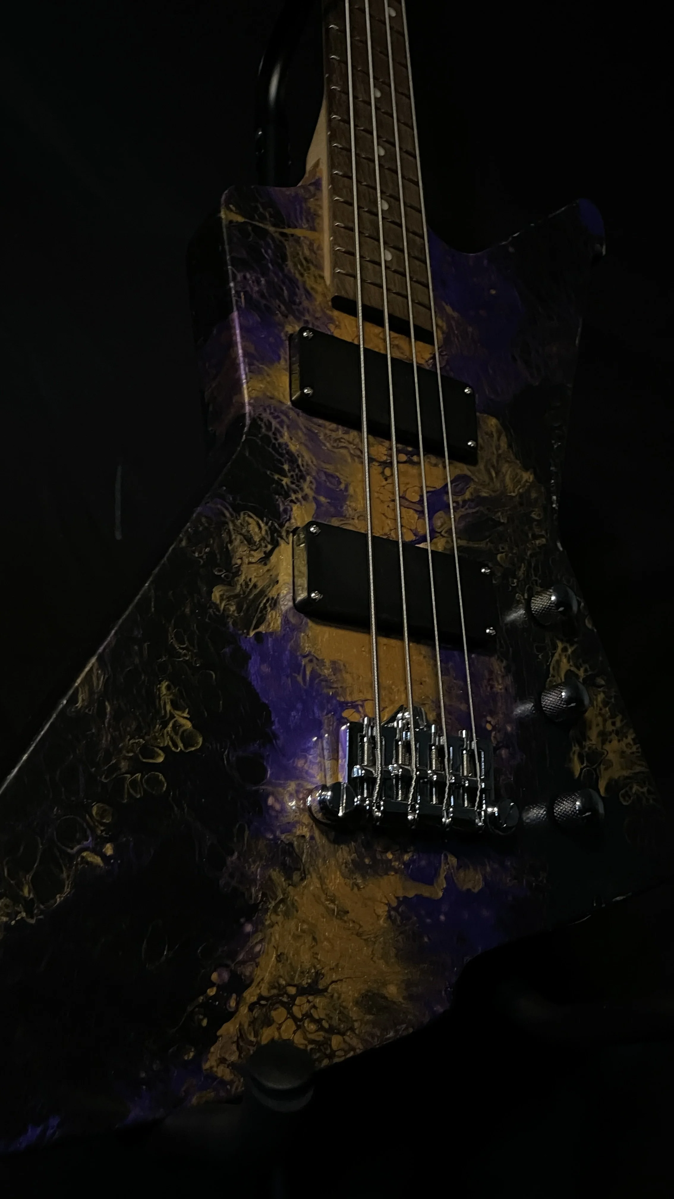 Purple, gold and black acrylic poured electric bass named Delphi from Grainrot Guitars.
