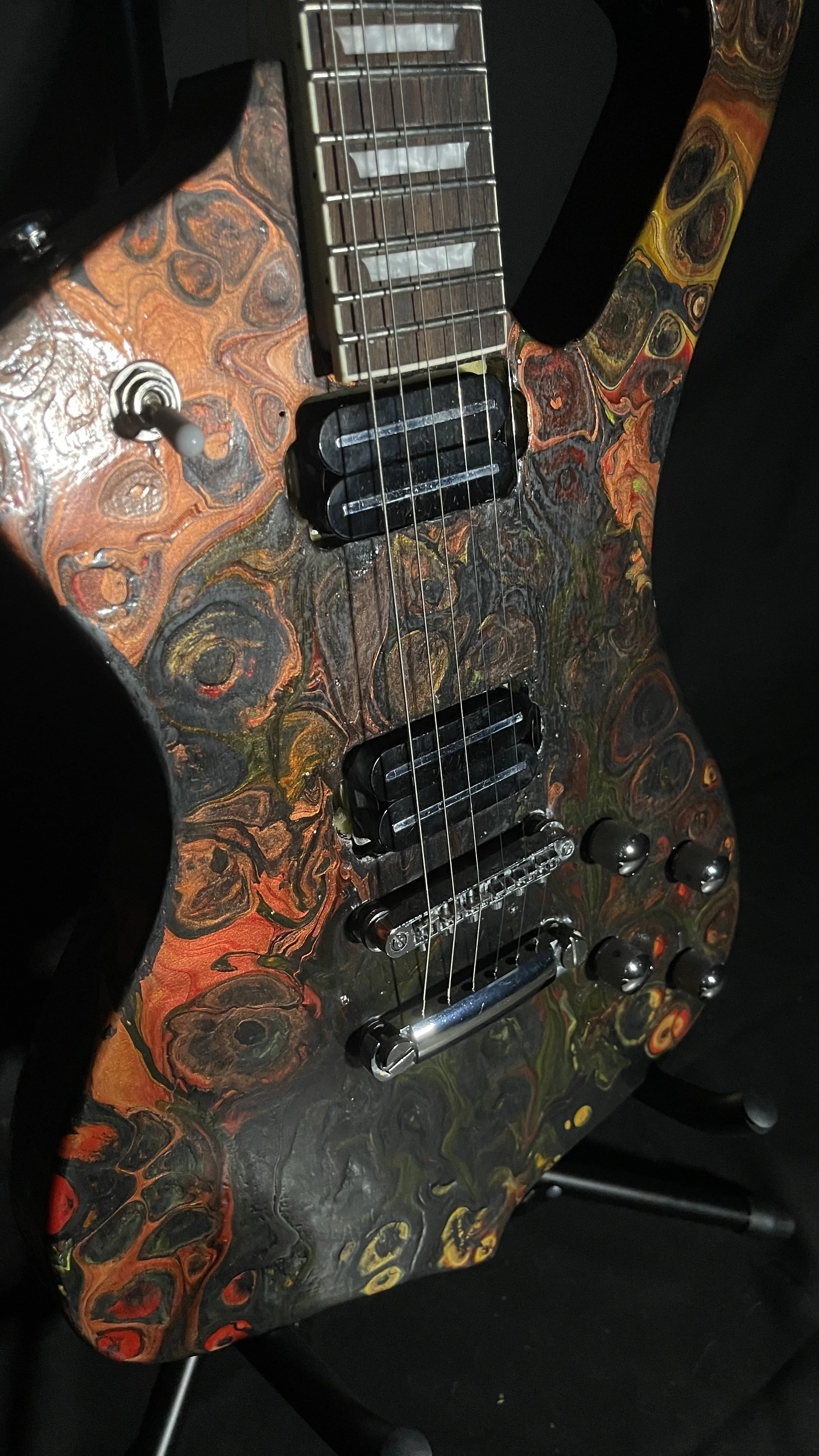 A black, red, orange and yellow electric guitar name Hephaestus by Grainrot Guitars