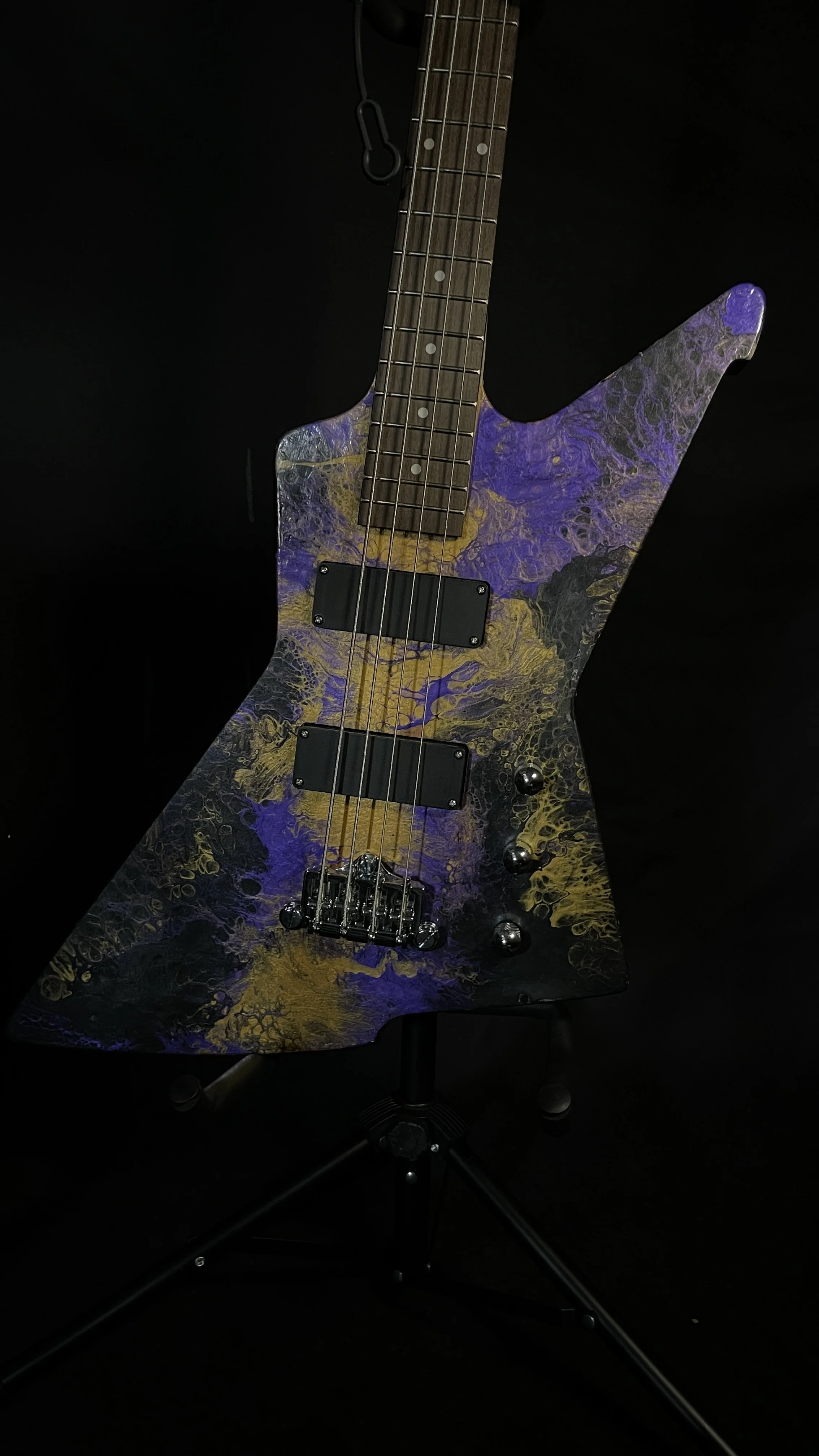 Purple, gold and black acrylic poured electric bass named Delphi from Grainrot Guitars.