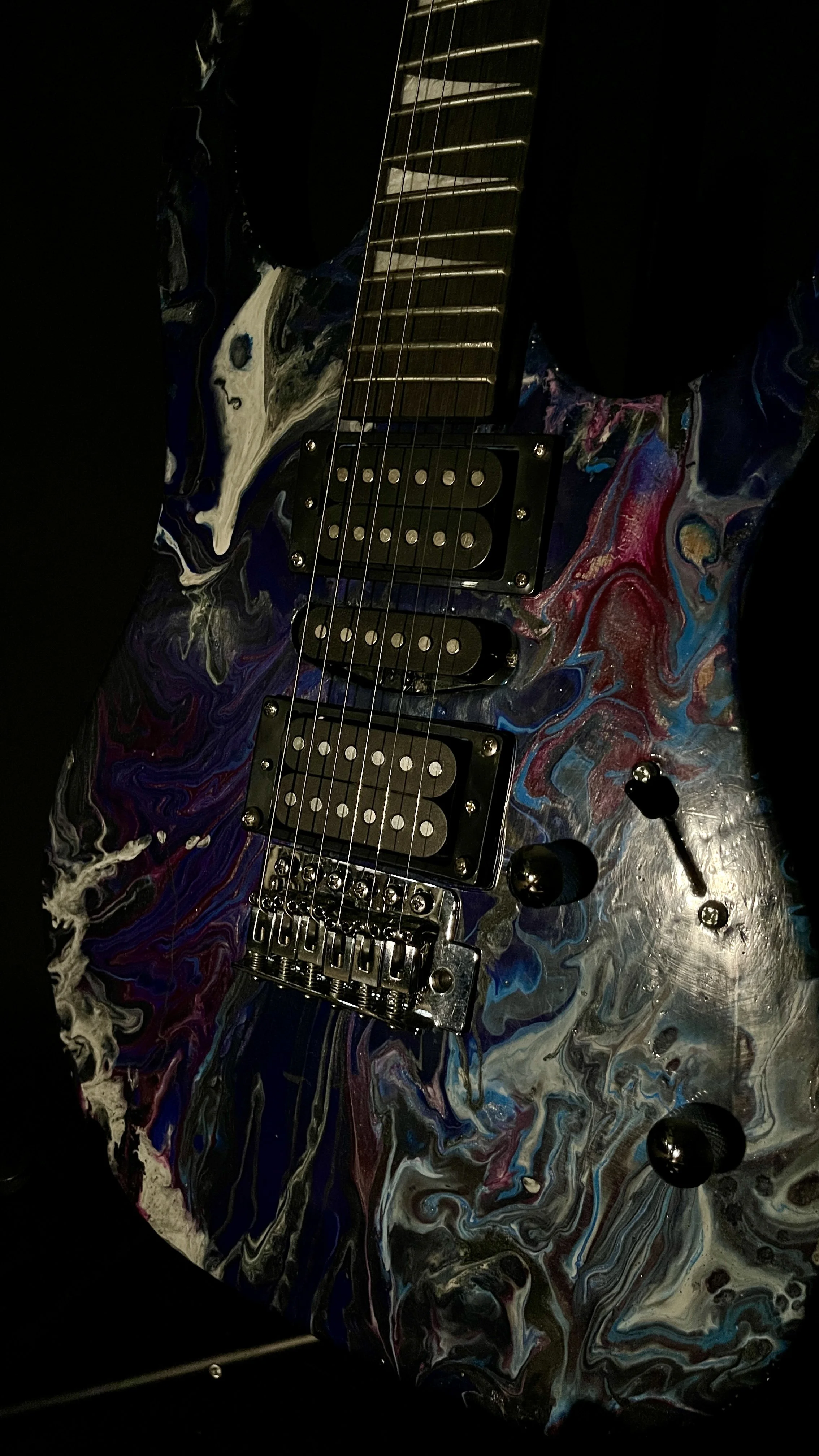 A black, white, blue and purple acrylic poured electric guitar named Nyx by Grainrot Guitars