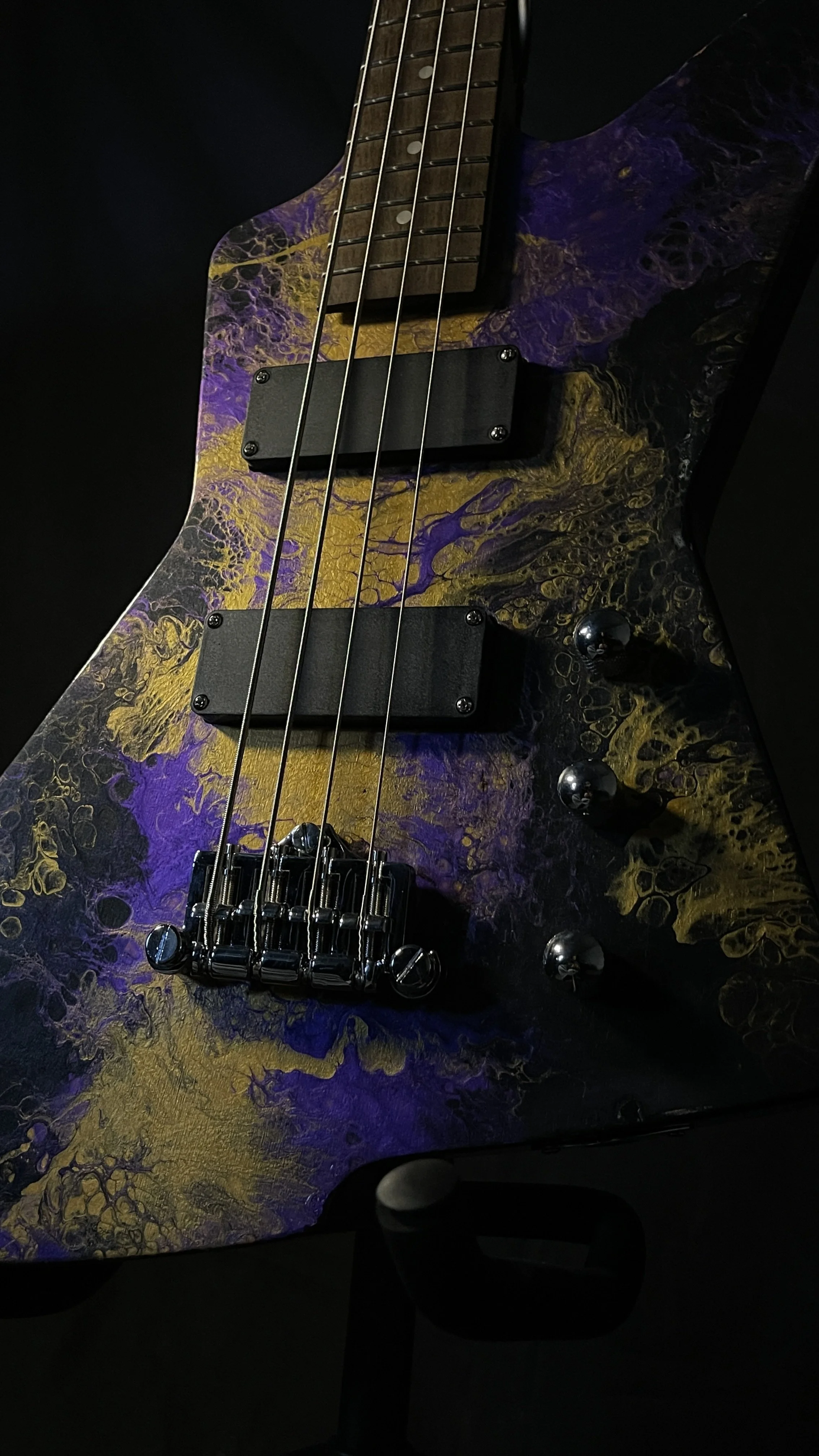 Purple, gold and black acrylic poured electric bass named Delphi from Grainrot Guitars.