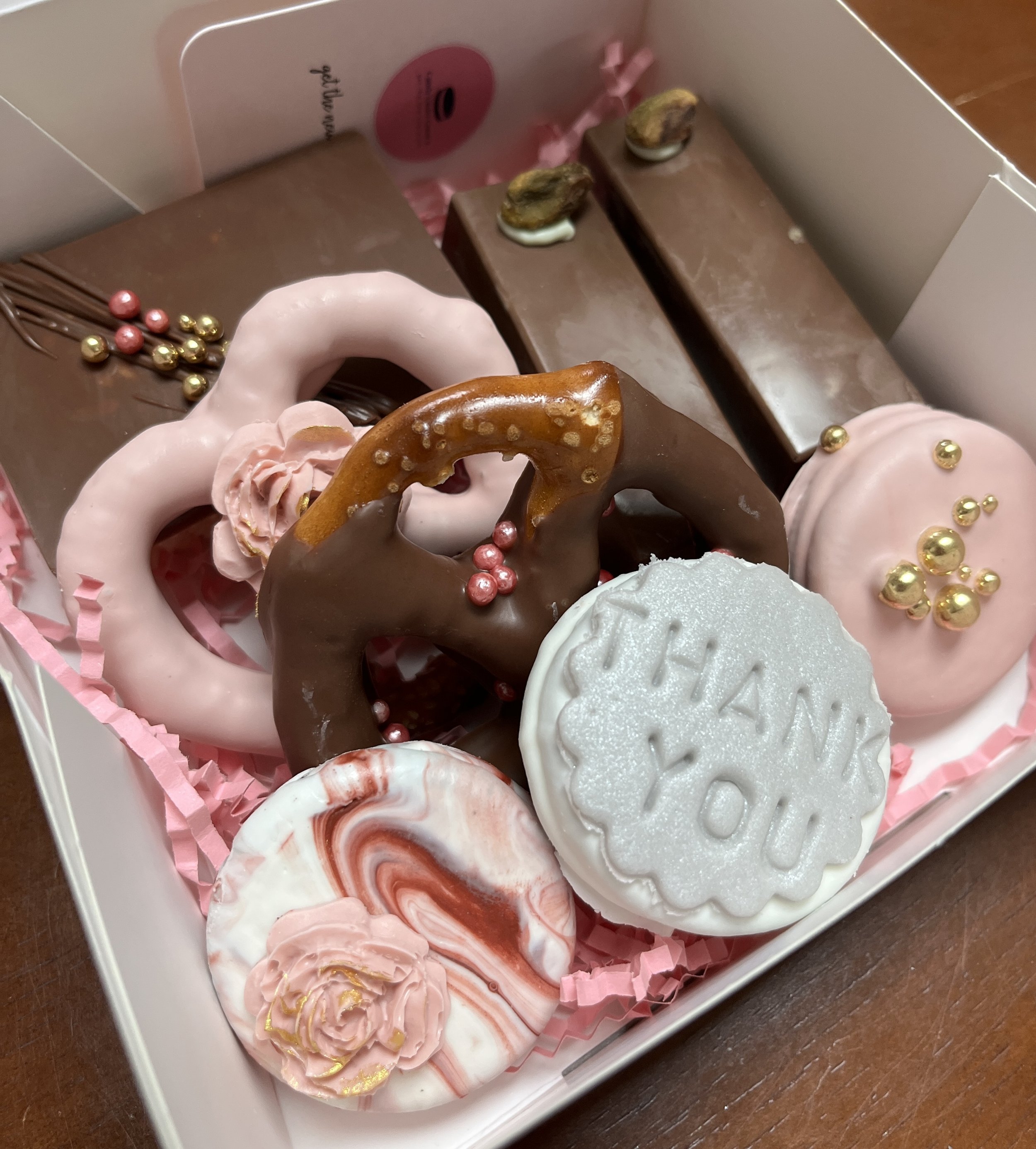 Corporate Gift Boxes filled with chocolate covered Oreos, pretzels, dubaii chocolate and rice krispy treats.