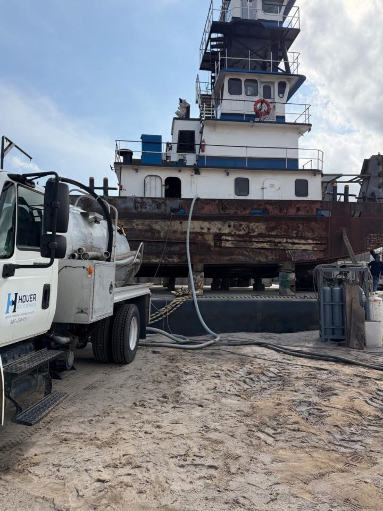 Hover Septic Services truck providing commercial pumping services at a marine vessel in Port Fourchon, Louisiana