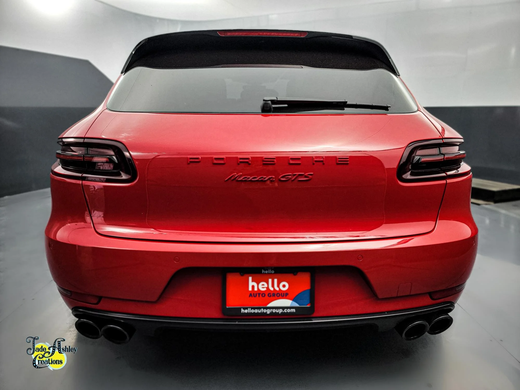 Red Porsche Macan GTS rear view in a showroom