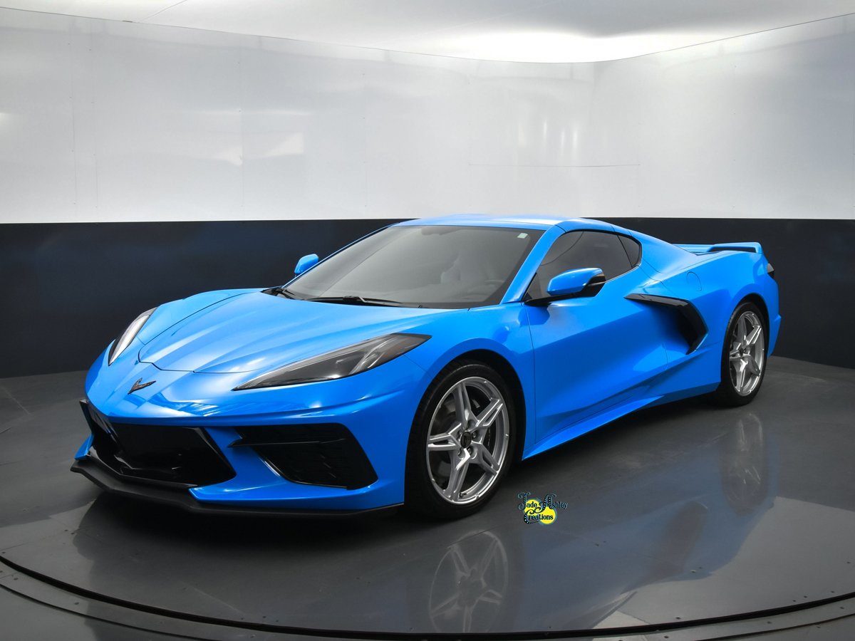 A blue sports car with sleek design in a showroom.