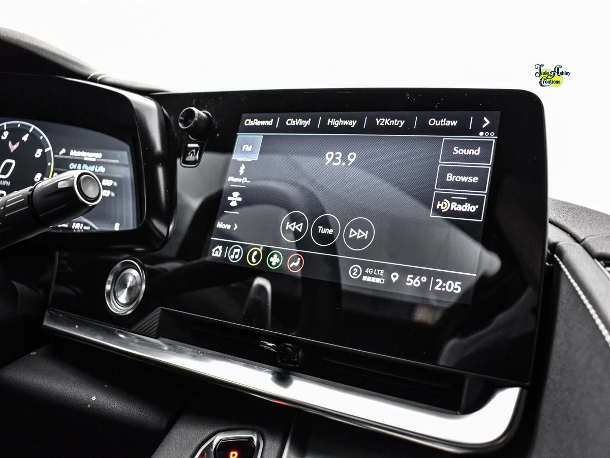 Car dashboard display showing a radio tuned to 93.9 FM, with controls for sound, browse, and HD radio, along with a digital clock, temperature, and signal information.