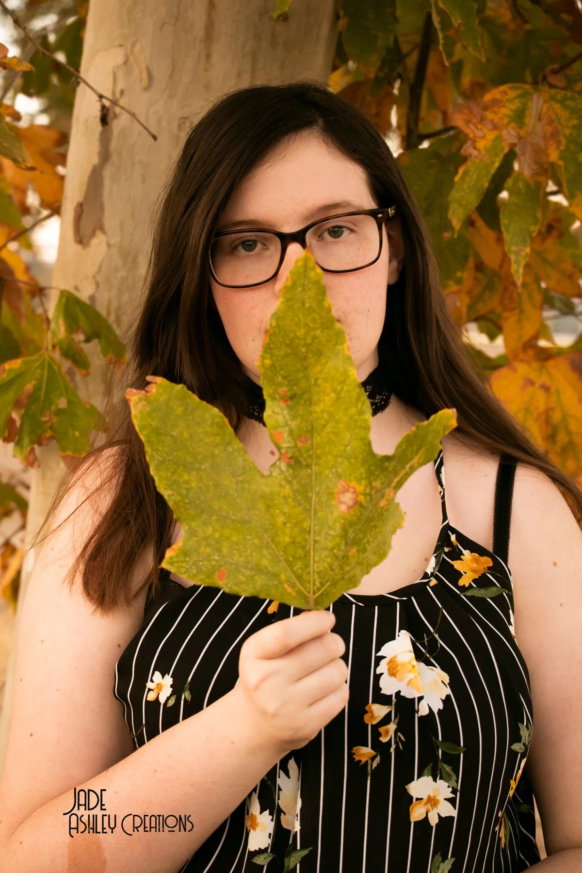 woman with leaf in hand
