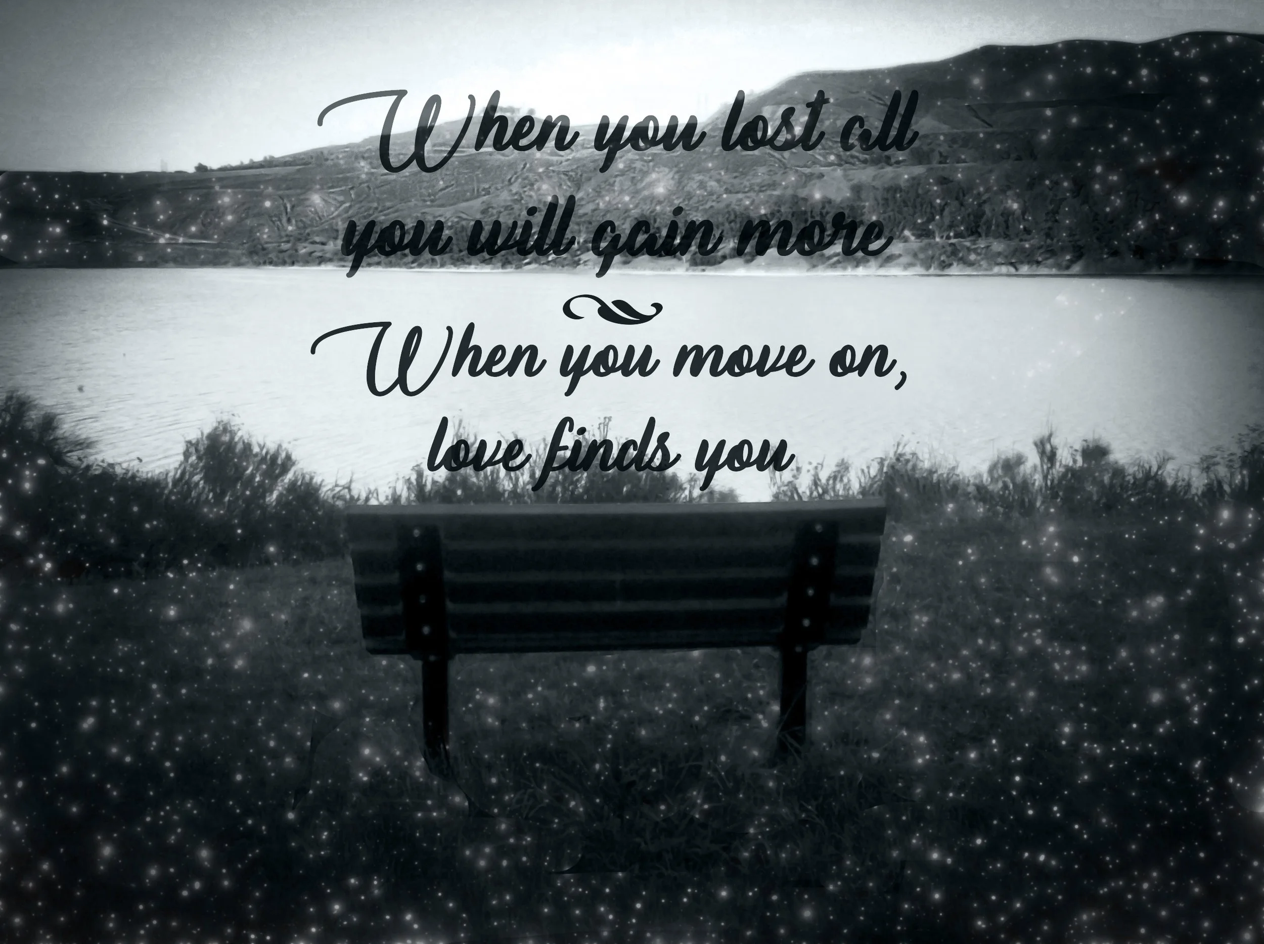 A black and white image of a lakeside scene with a bench facing water and distant hills, overlaid with a quote: 'When you lost all you will gain more and when you move on, love finds you.'
