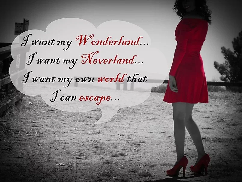 A woman in a red dress and high heels standing outdoors on a dirt path with trees in the background. A speech bubble with the text: 'I want my Wonderland... I want my Neverland... I want my own world that I can escape...'