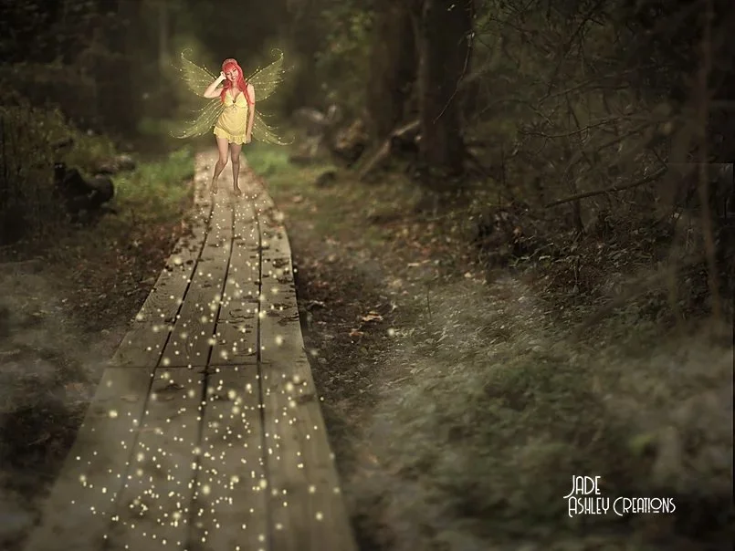 Fairy with red hair, yellow dress, and glowing wings standing on a wooden path in a dark forest, with glowing lights around her.
