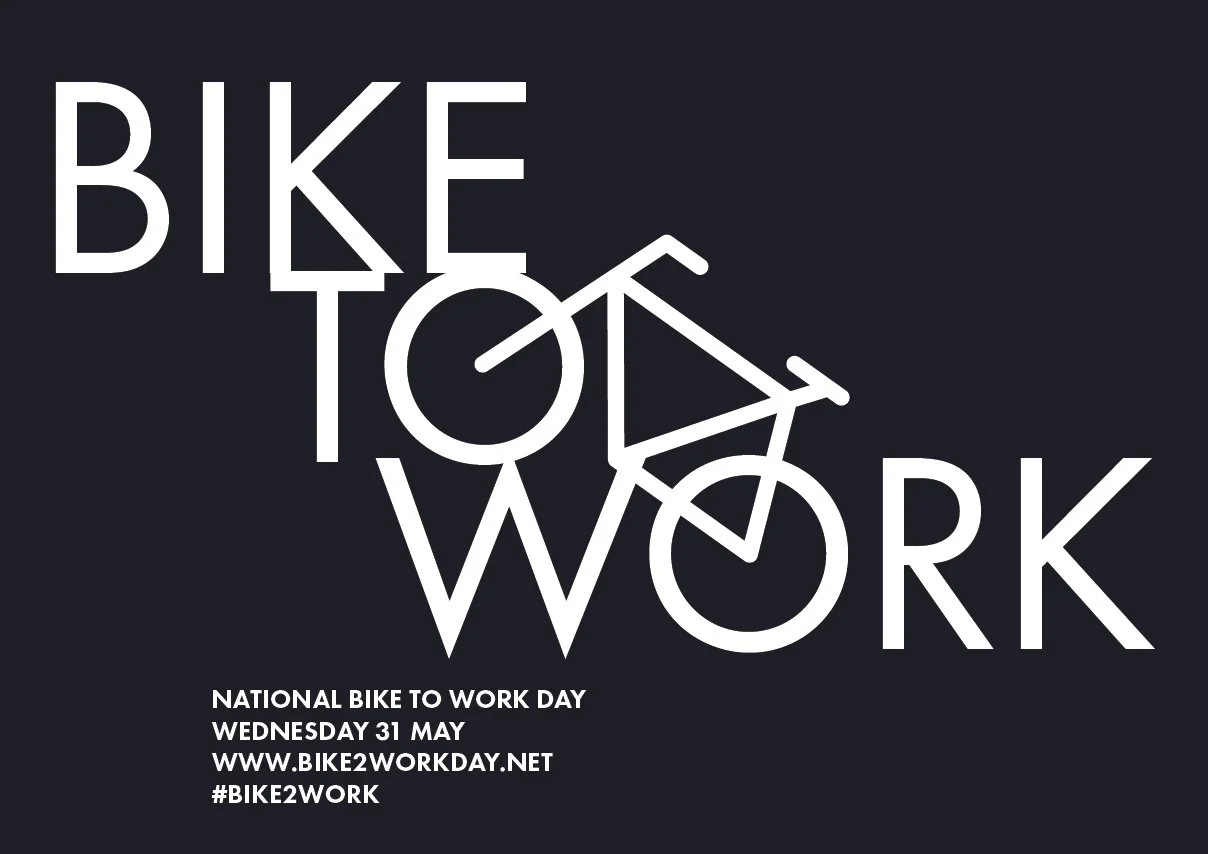 Graphic for Bike to Work Day with large stylized white text on black background, reading 'Bike to Work.' Additional text includes details for National Bike to Work Day on Wednesday, May 31, with a website and hashtag for the event.
