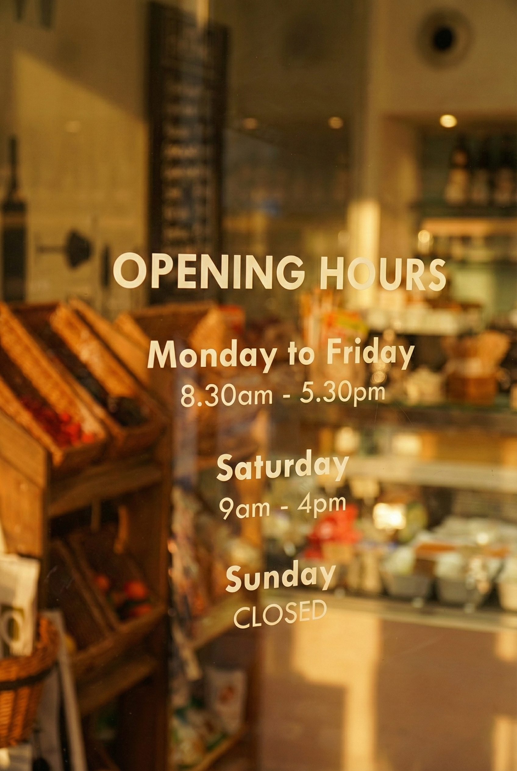 Sign with store opening hours, indicating open Monday to Saturday from 8:30 am to 5:30 pm, and closed on Sunday.