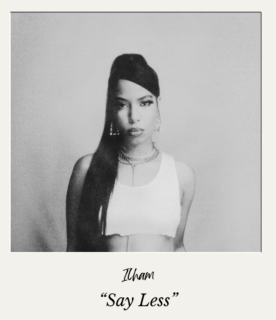 A black-and-white portrait of a woman wearing a sleeveless top, layered necklaces, and earrings, with her long hair styled to one side, against a plain background.