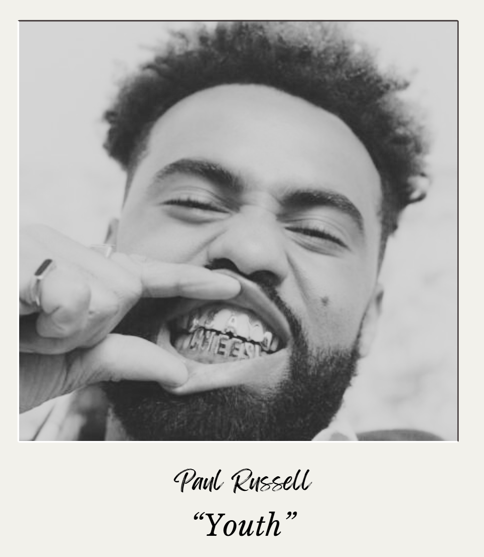 A black-and-white portrait of Paul Russell