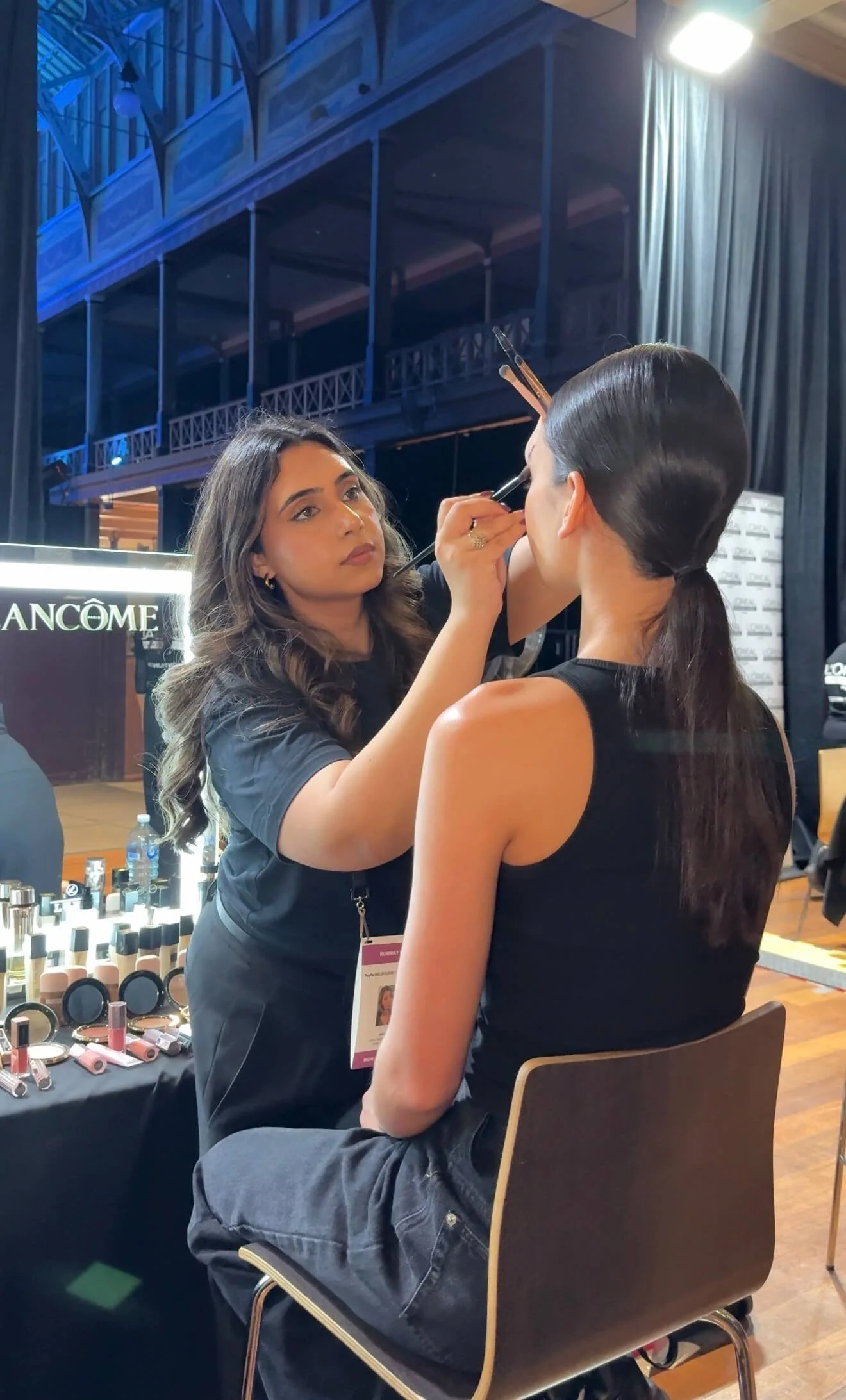 A high-quality photo of a close-up of Archie doing a professional makeup application.