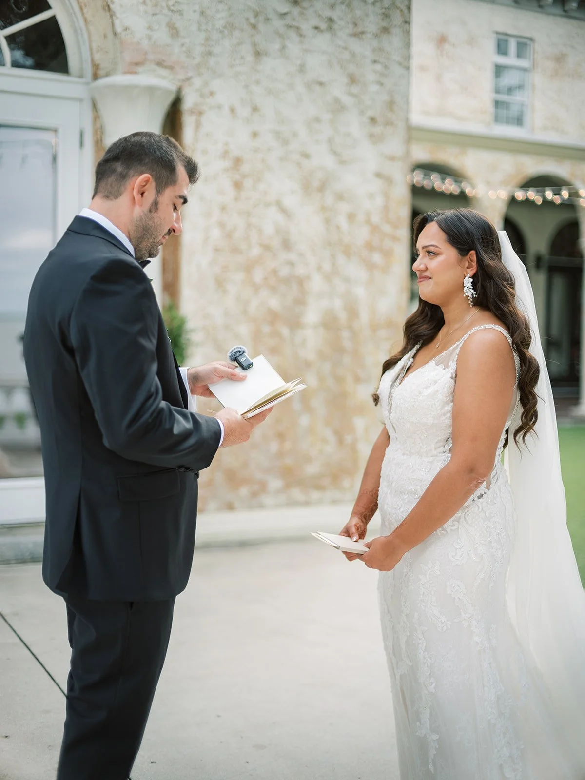 Groom Reading Vows to Teary Bride
