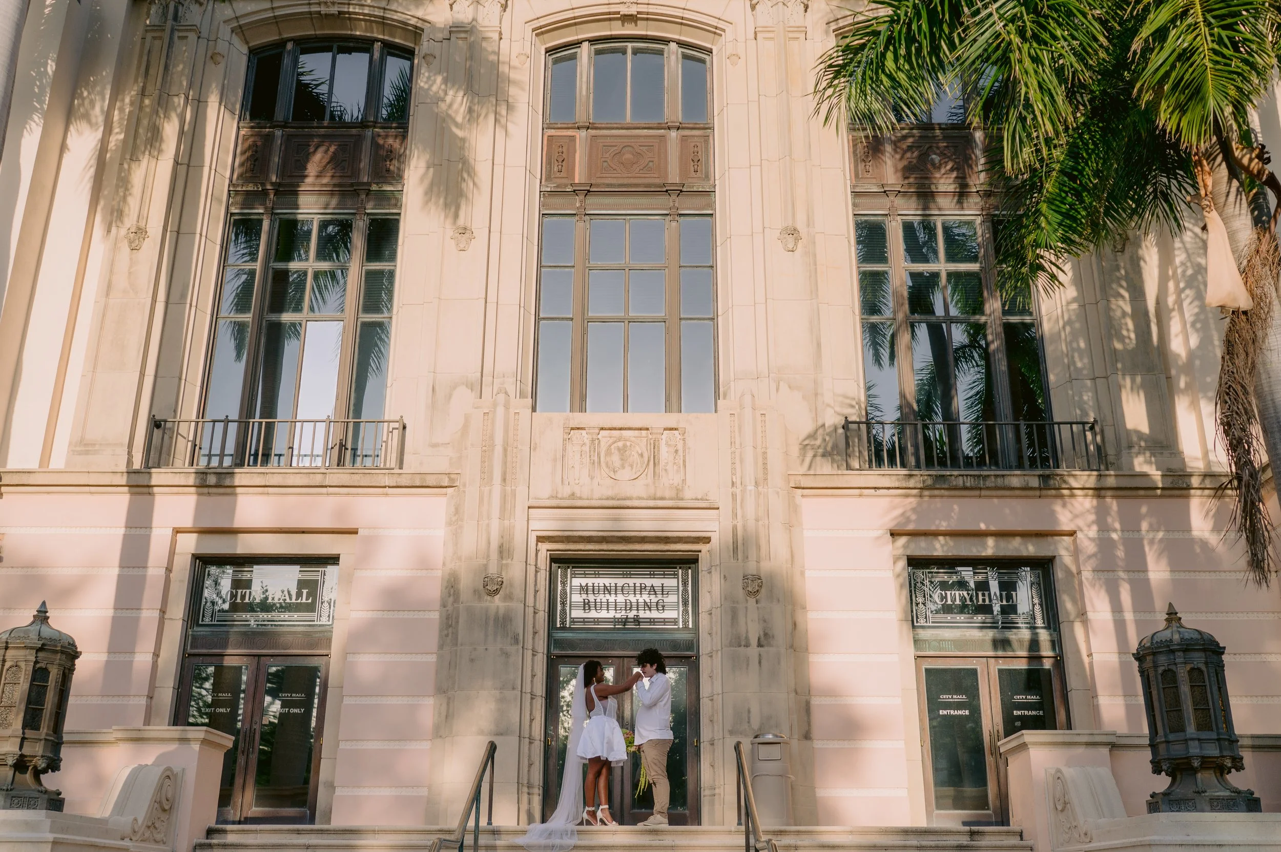 Close up details of a modern short elopement dress and custom bridal jewelry before a downtown St Petersburg courthouse wedding