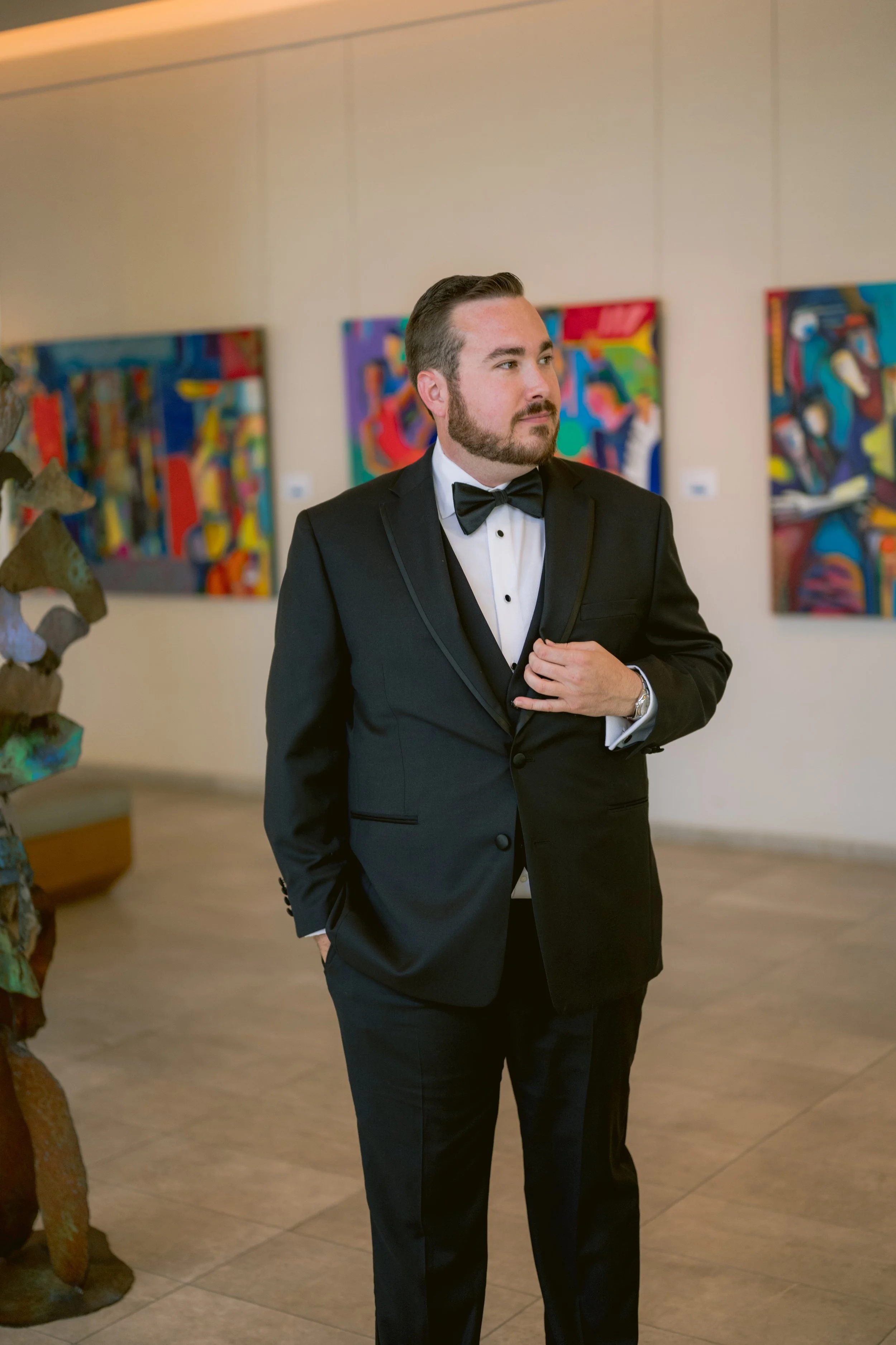 Ben pinning a simple white boutonniere onto his jacket at Art Ovation Hotel, minutes before leaving for the historic Sarasota courthouse.