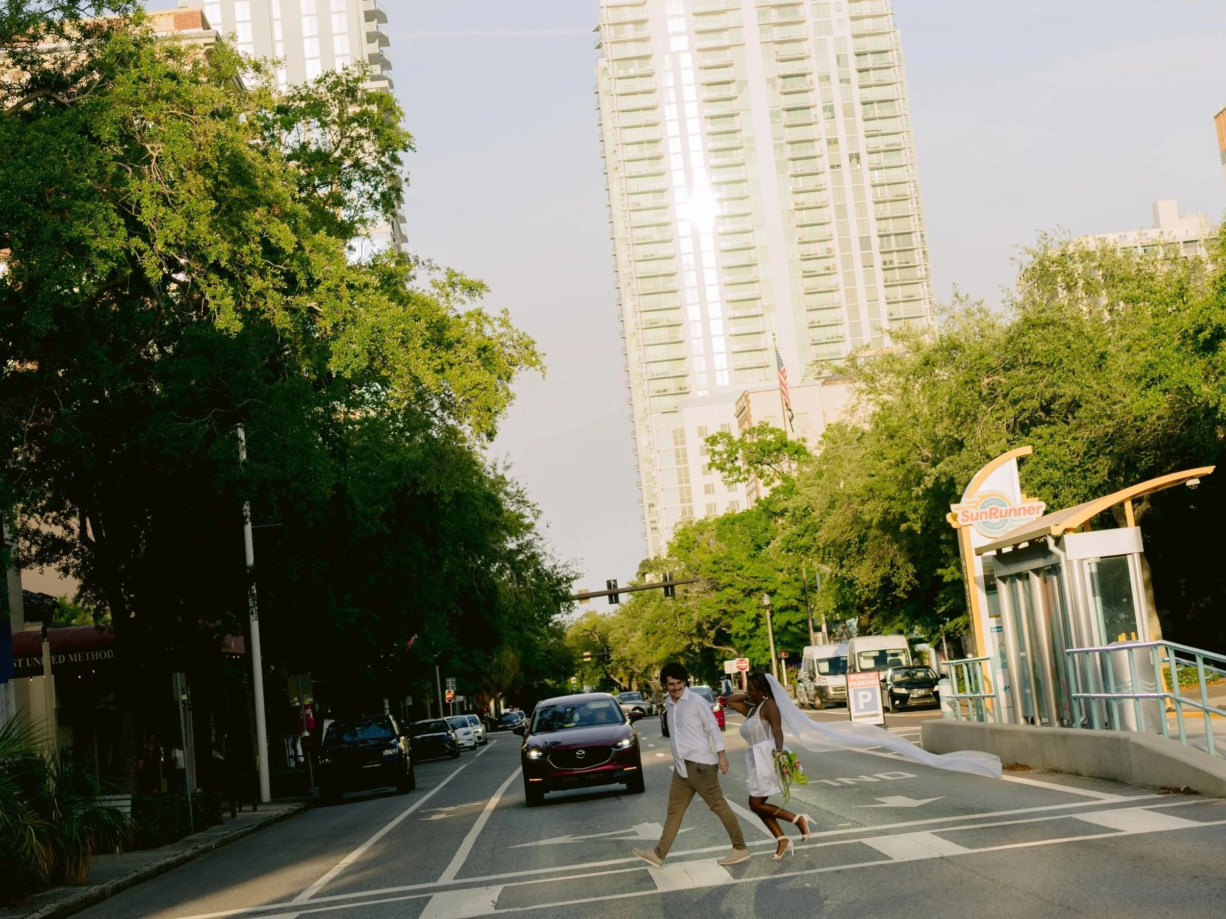 Modern Florida crosswalk elopement portrait with dramatic bridal veil trailing by Still by Hernan | Florida wedding content creator Let Me Woo You | Model Sarah from Tampa.jpg