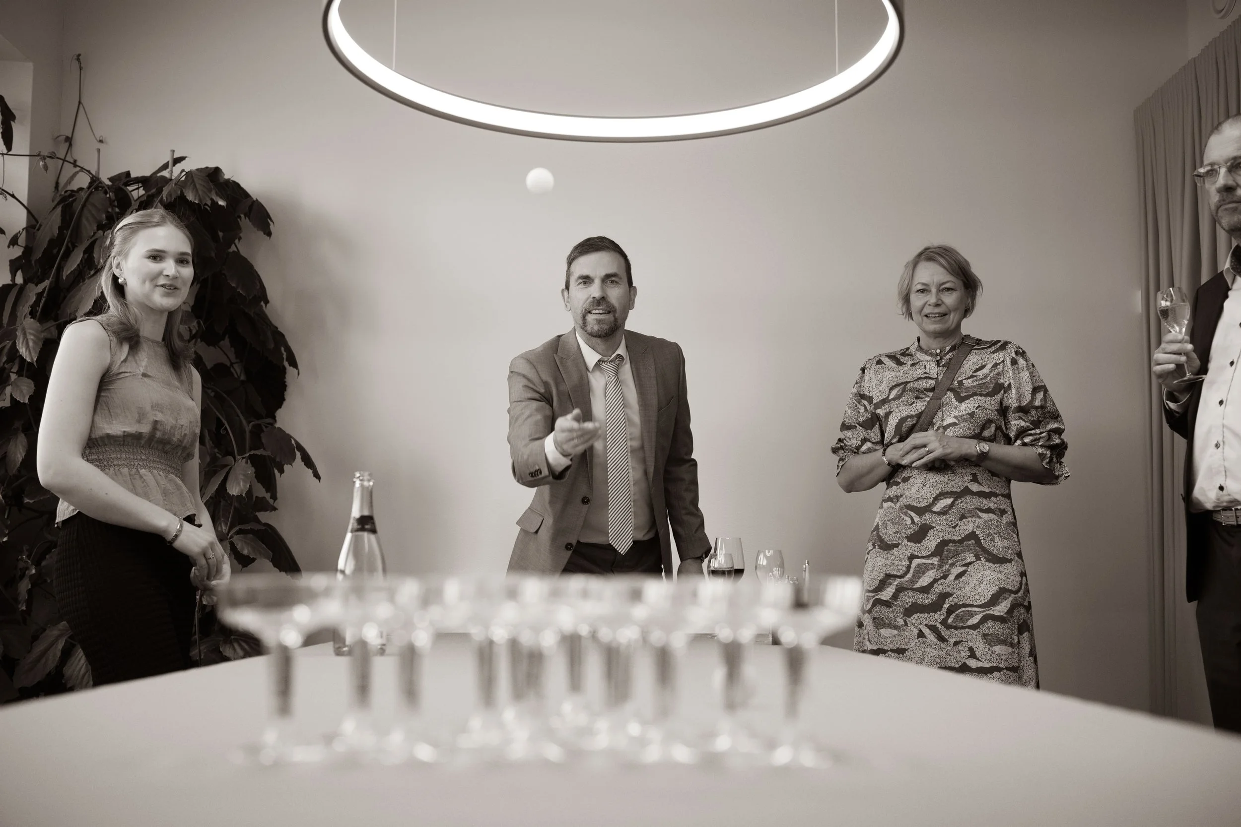 People playing a game of beer pong at a party or gathering.
