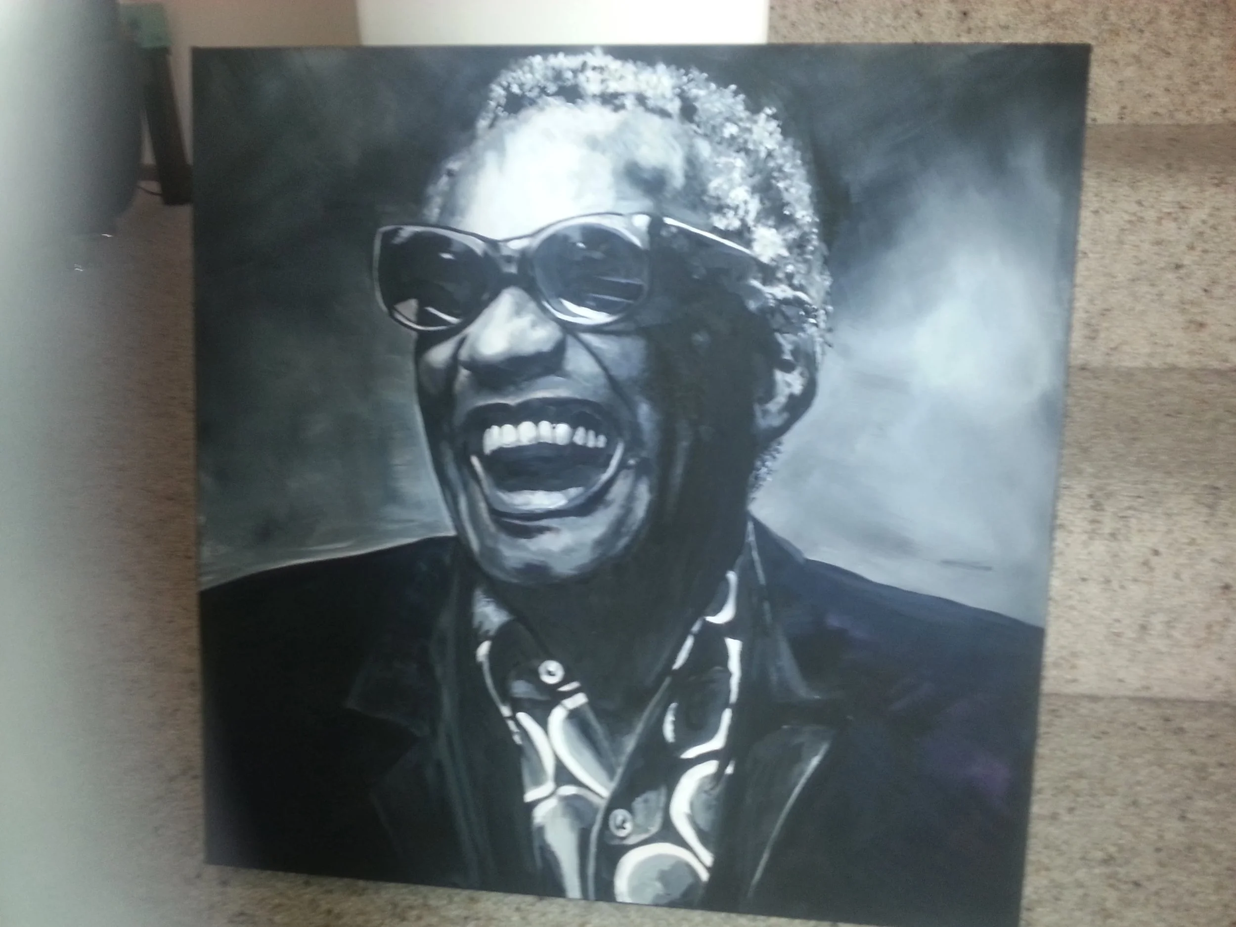 Black and white portrait of Ray Charles wearing sunglasses, singing the blues.