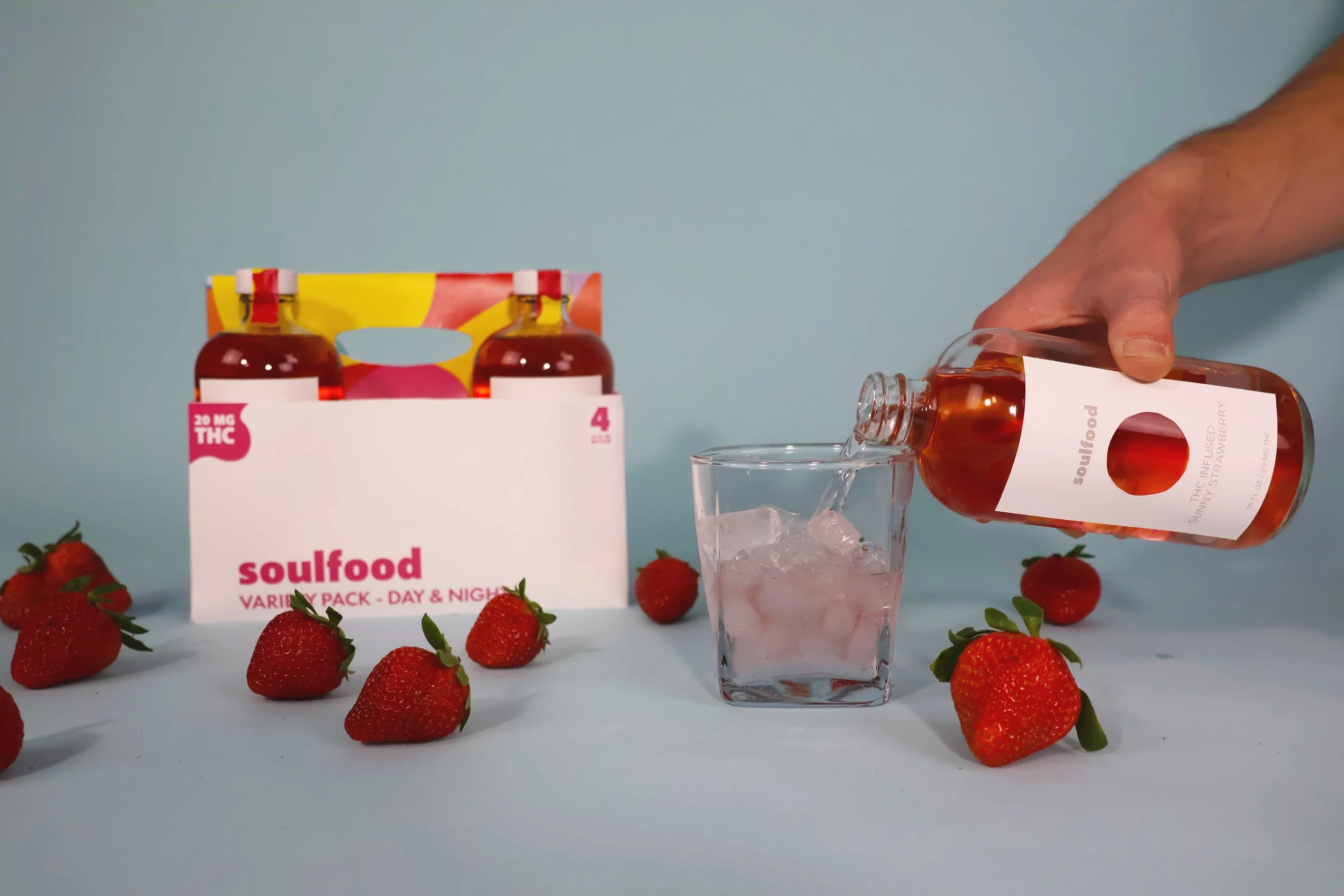 Man pouring a Day Drink into a glass of ice.