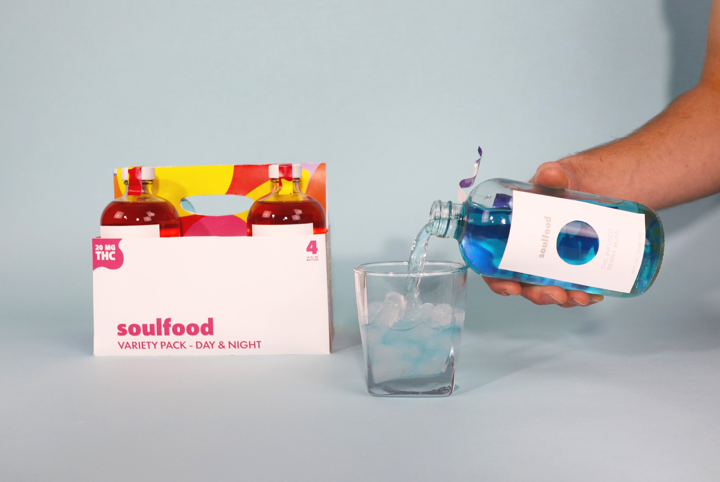 Man pouring a Night Drink into a glass of ice.