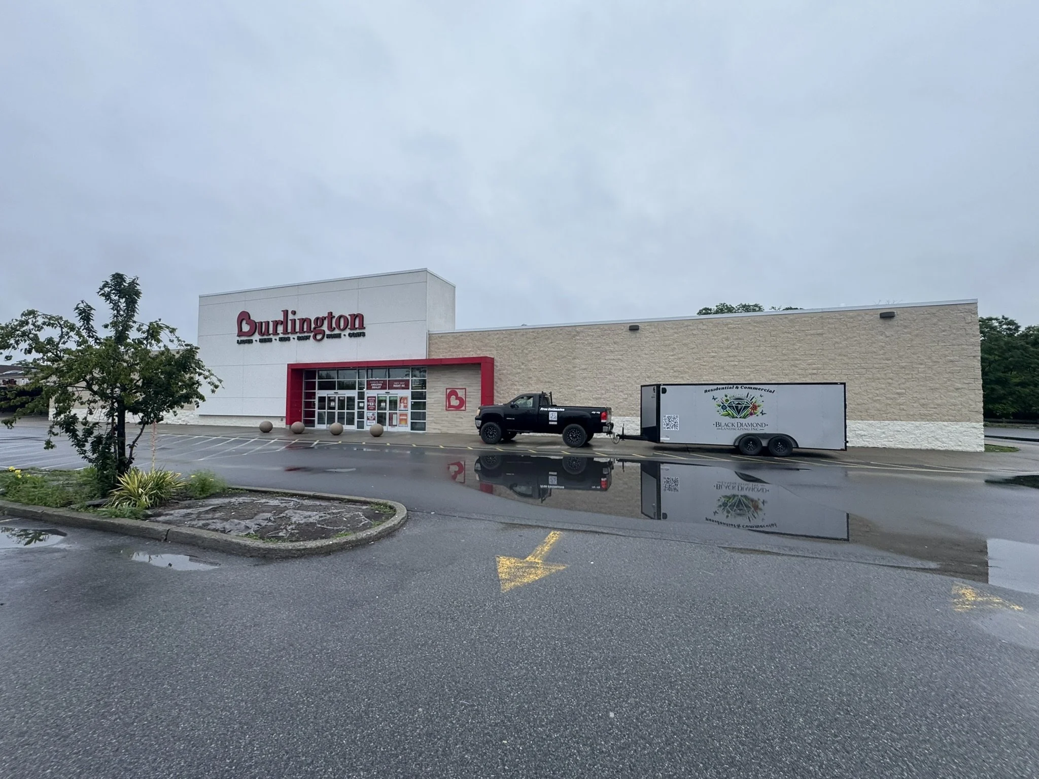 Commercial landscaping maintenance team mowing and trimming a business property in Dutchess County NY