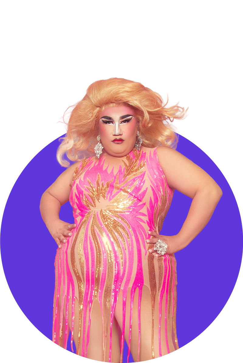 A person with long blonde hair, bold makeup, and earrings wearing a pink and gold sequined dress with a dripping effect, standing with hands on hips against a purple background.