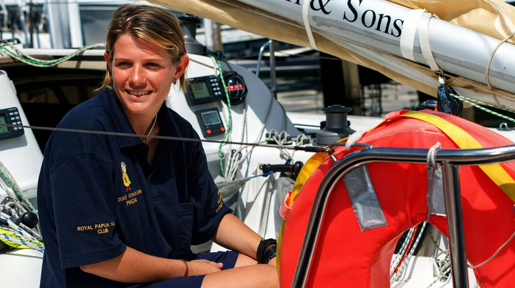 Liz Wardley seated aboard a sailing yacht during her professional sailing career.