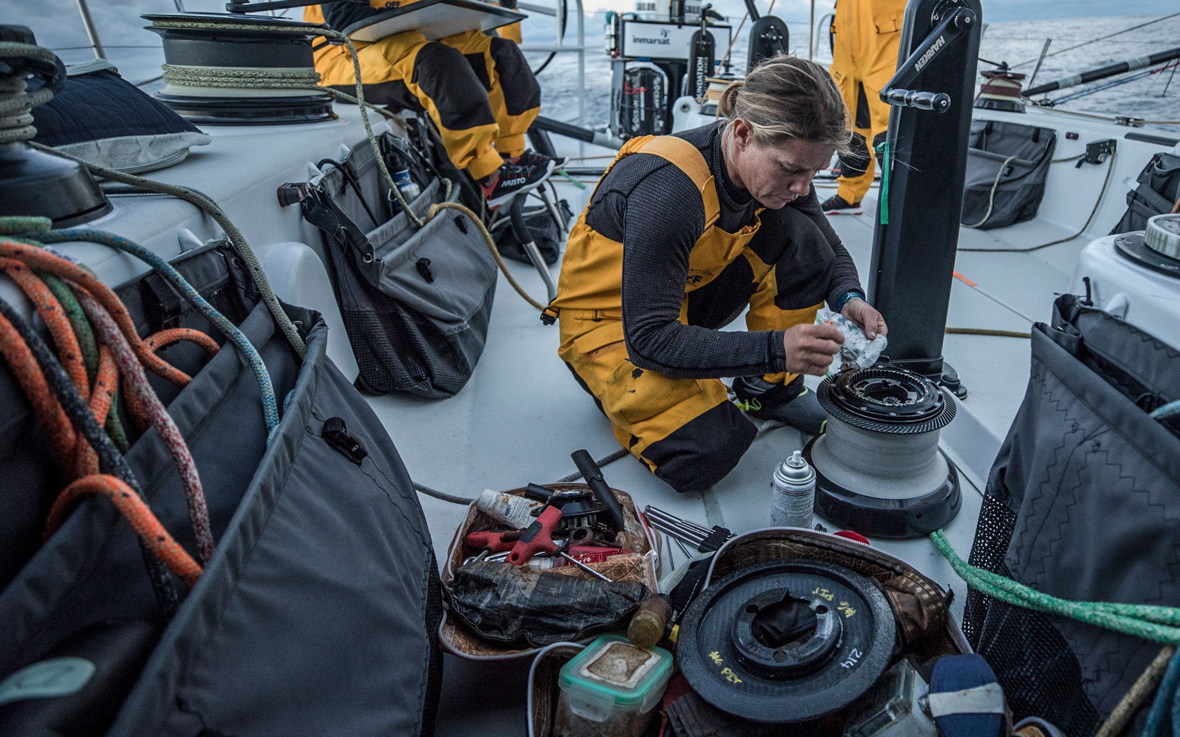 Liz Wardley carrying out maintenance on a racing sailing yacht.