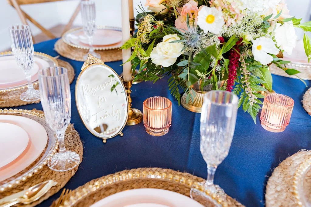 Elegant centerpiece table setup with candles and chargers at 1860 Schulhaus