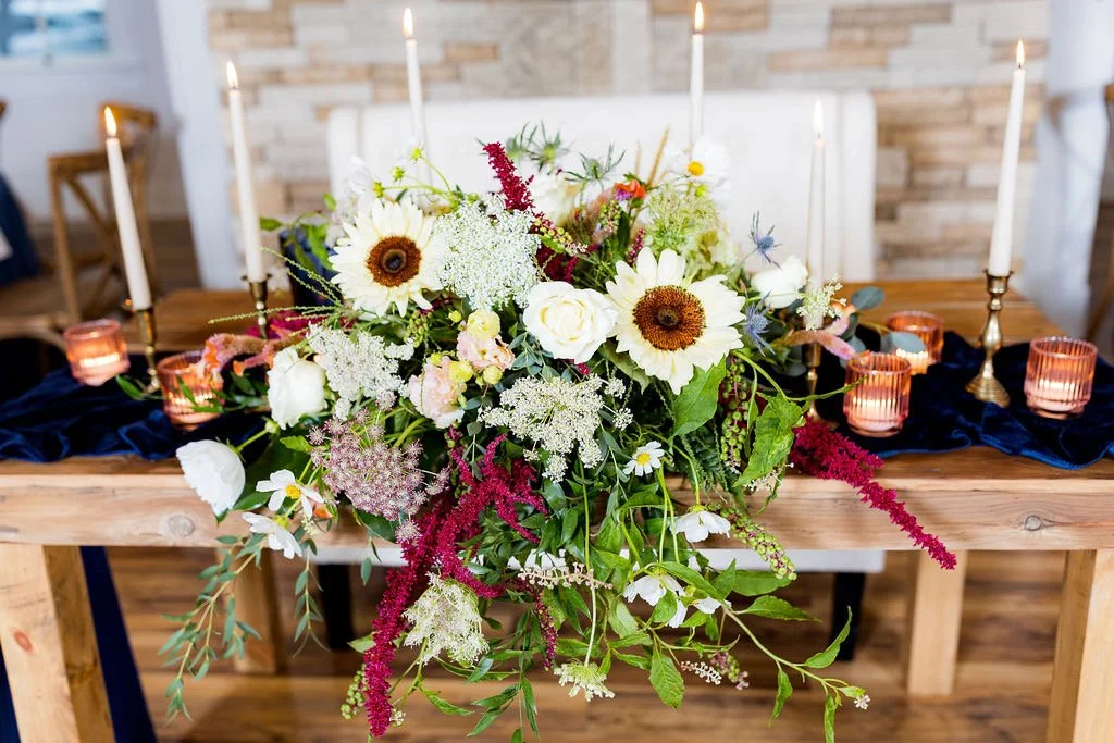 Elegant head table setup with candles and chargers at 1860 Schulhaus