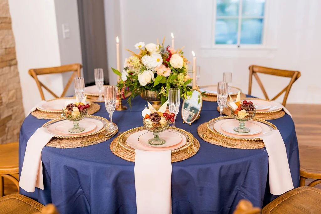 Elegant wedding table setup with candles and chargers at 1860 Schulhaus Micro wedding venue
