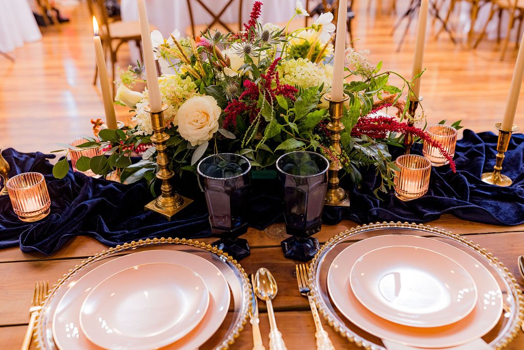 Elegant head table setup with candles and chargers at 1860 Schulhaus