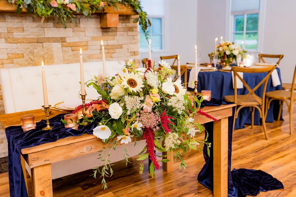 beautiful head table setup with candles and chargers at 1860 Schulhaus micro wedding venue